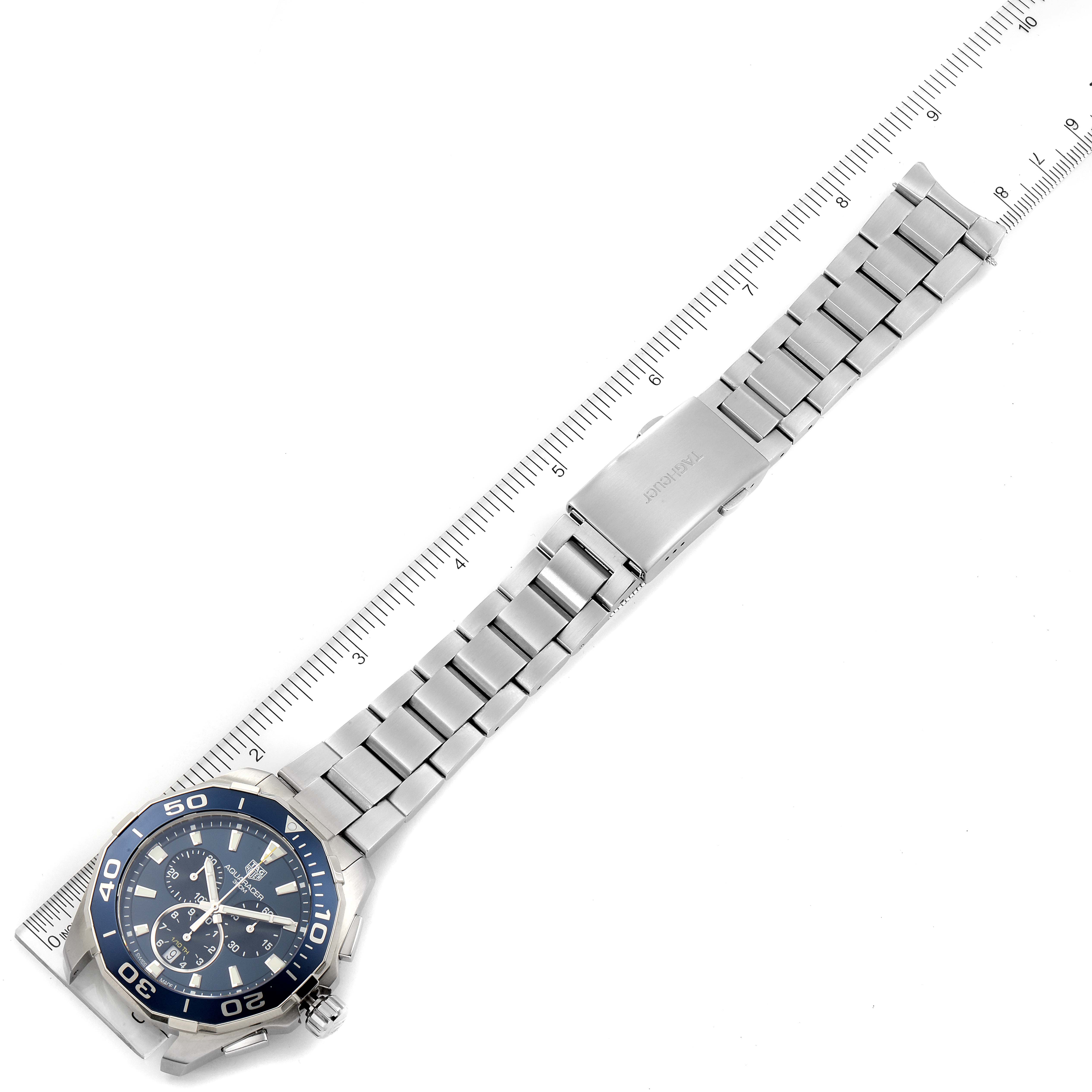 The image shows a Tag Heuer Aquaracer CAY111B.BA0927 Men's Stainless Steel Blue Dial CAY111B.BA0927 Men's Stainless Steel Blue Dial watch laid flat with a metal bracelet and a ruler for scale.