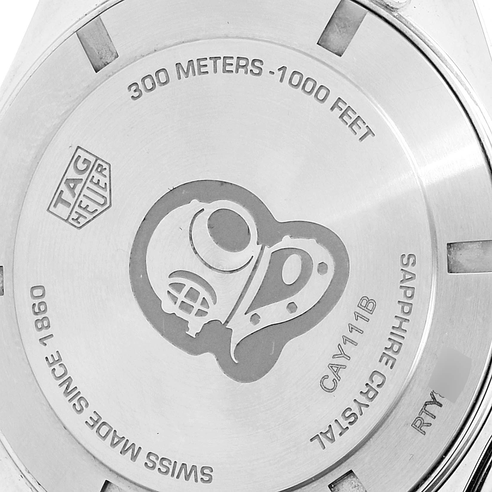 The image shows the back case of a Tag Heuer Aquaracer CAY111B.BA0927 Men's Stainless Steel Blue Dial CAY111B.BA0927 Men's Stainless Steel Blue Dial watch with engravings and a diving helmet design.