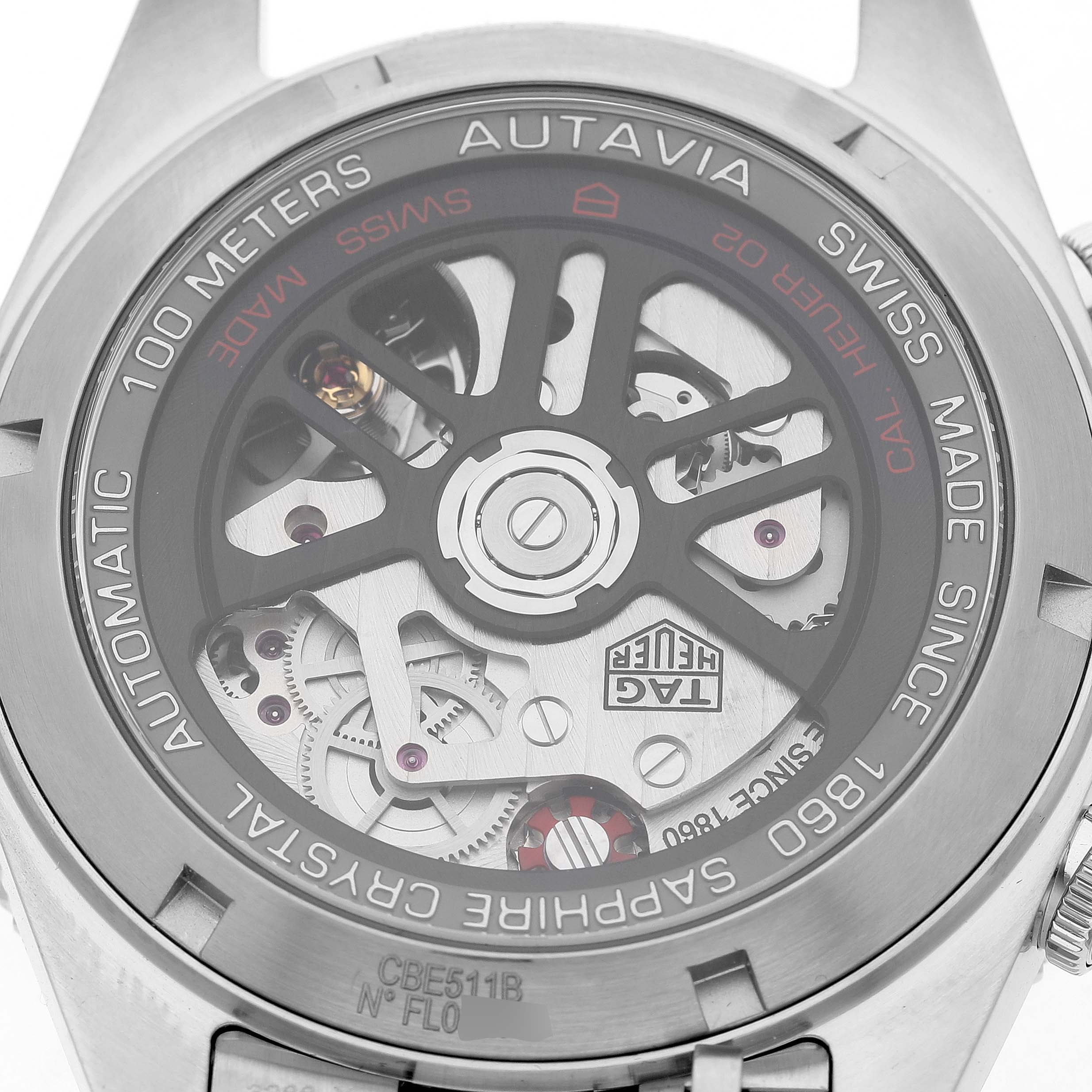 The image shows the back view of a Tag Heuer Autavia CBE511B Men's Stainless Steel Silver Dial watch, highlighting its mechanical movement and sapphire crystal.