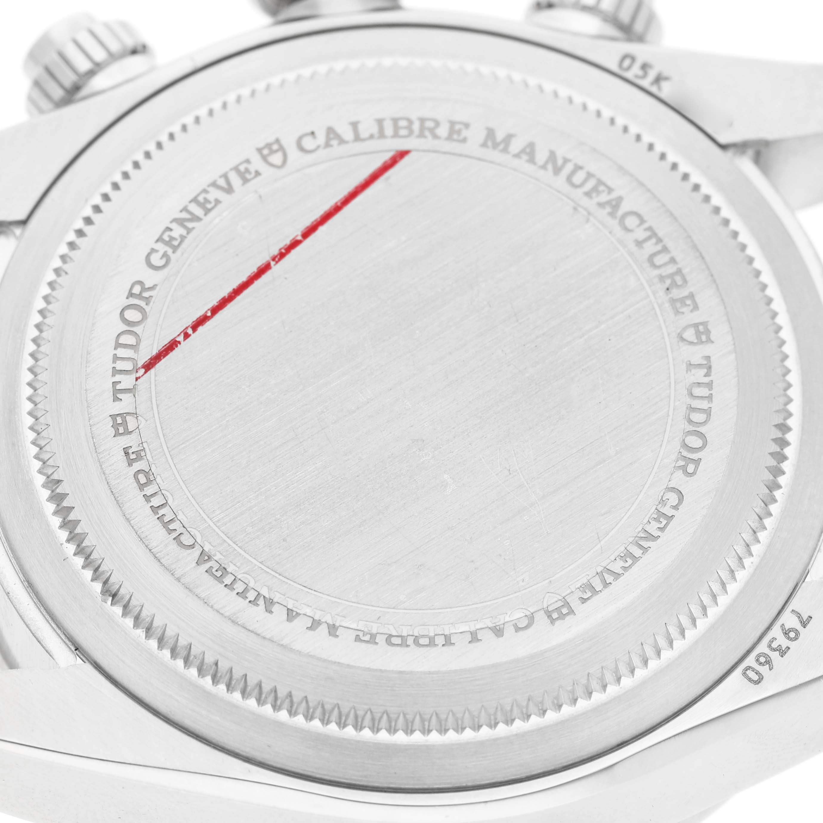 The image shows the back case of a Tudor Heritage Chrono 79360N Men's Stainless Steel Black Dial watch, featuring branding and inscriptions.