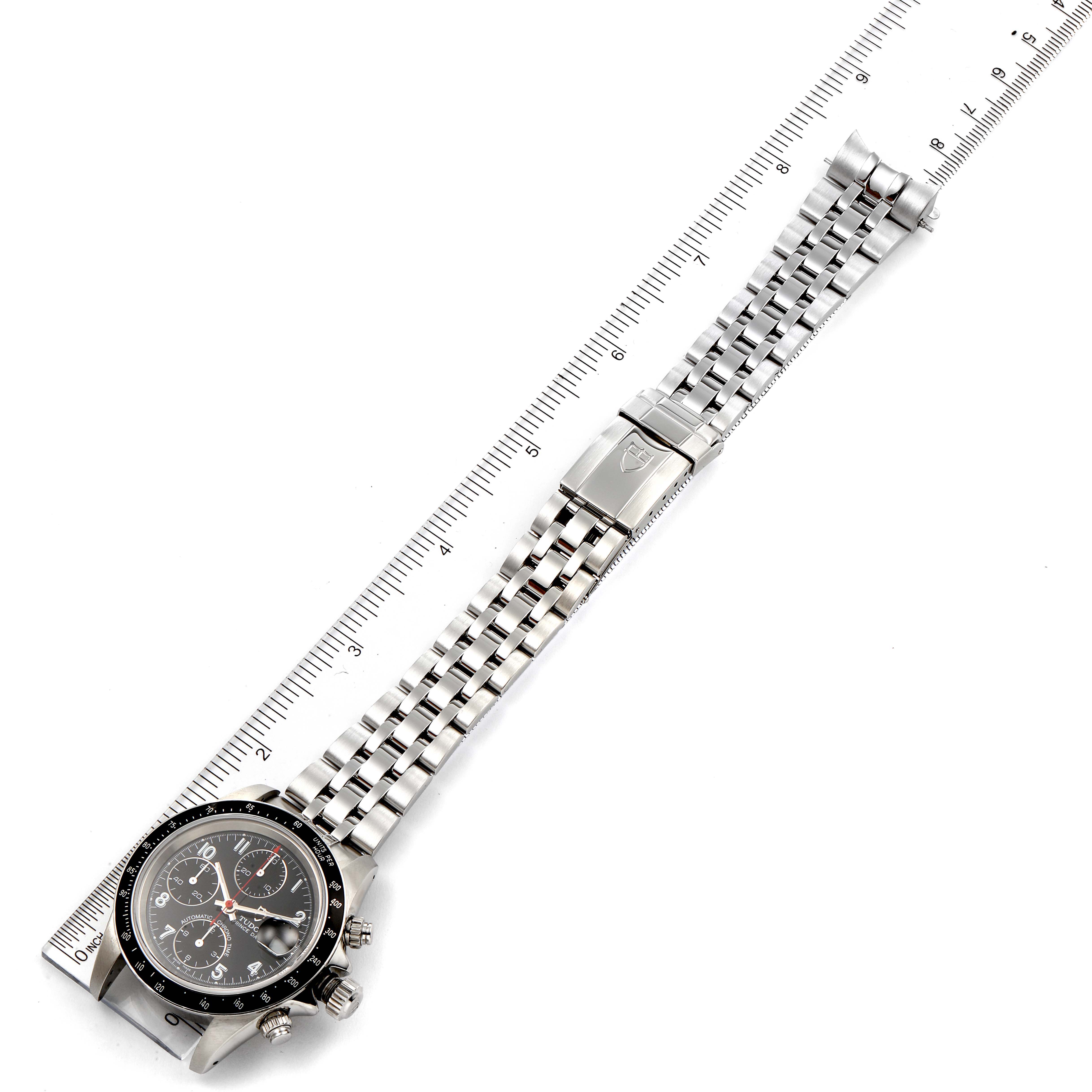 The Tudor Prince 79260 Men
s Stainless Steel Black Dial 79260 Men
s Stainless Steel Black Dial watch is shown flat with its dial and bracelet, alongside a ruler for measurement.