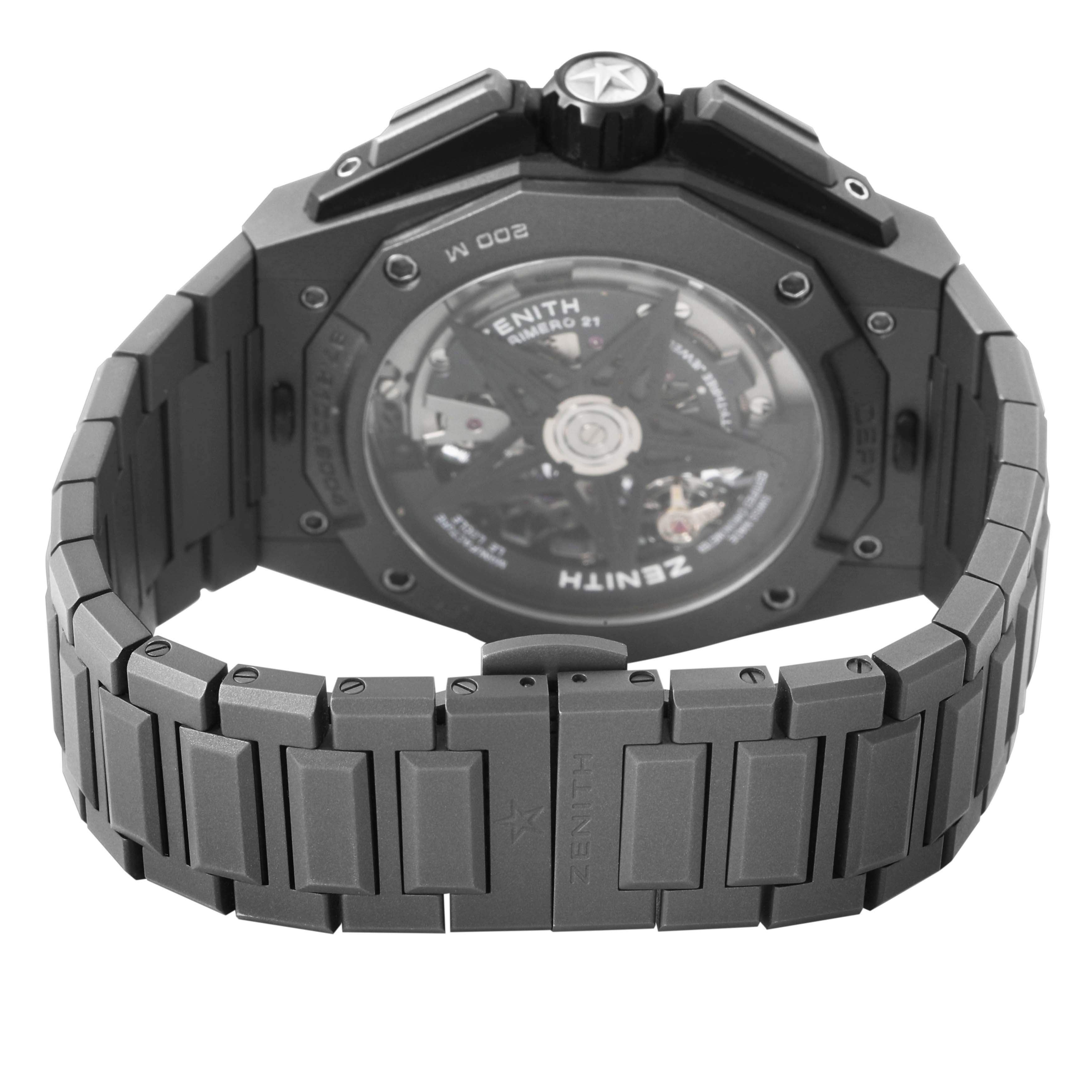 The image shows the back view and bracelet of the Zenith Defy 97.9100.9004 Men's Titanium Grey Dial watch, highlighting the open case back and metal links.