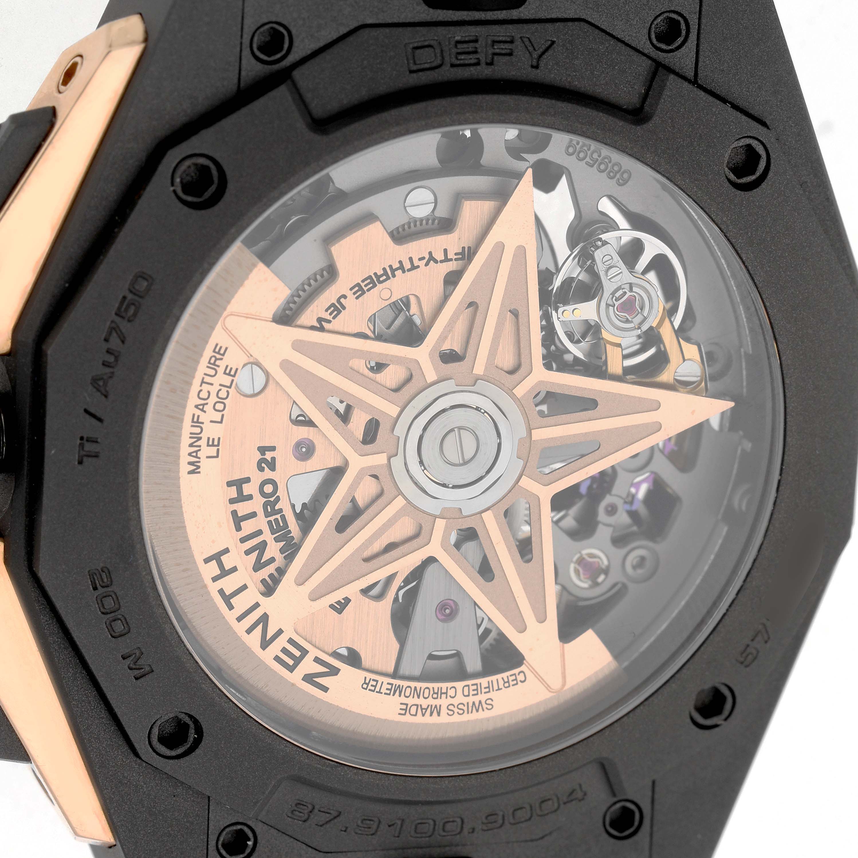 The image shows the back of a Zenith Defy 87.9100.9004 Men's Titanium Grey Dial watch, highlighting its transparent case back and movement components.