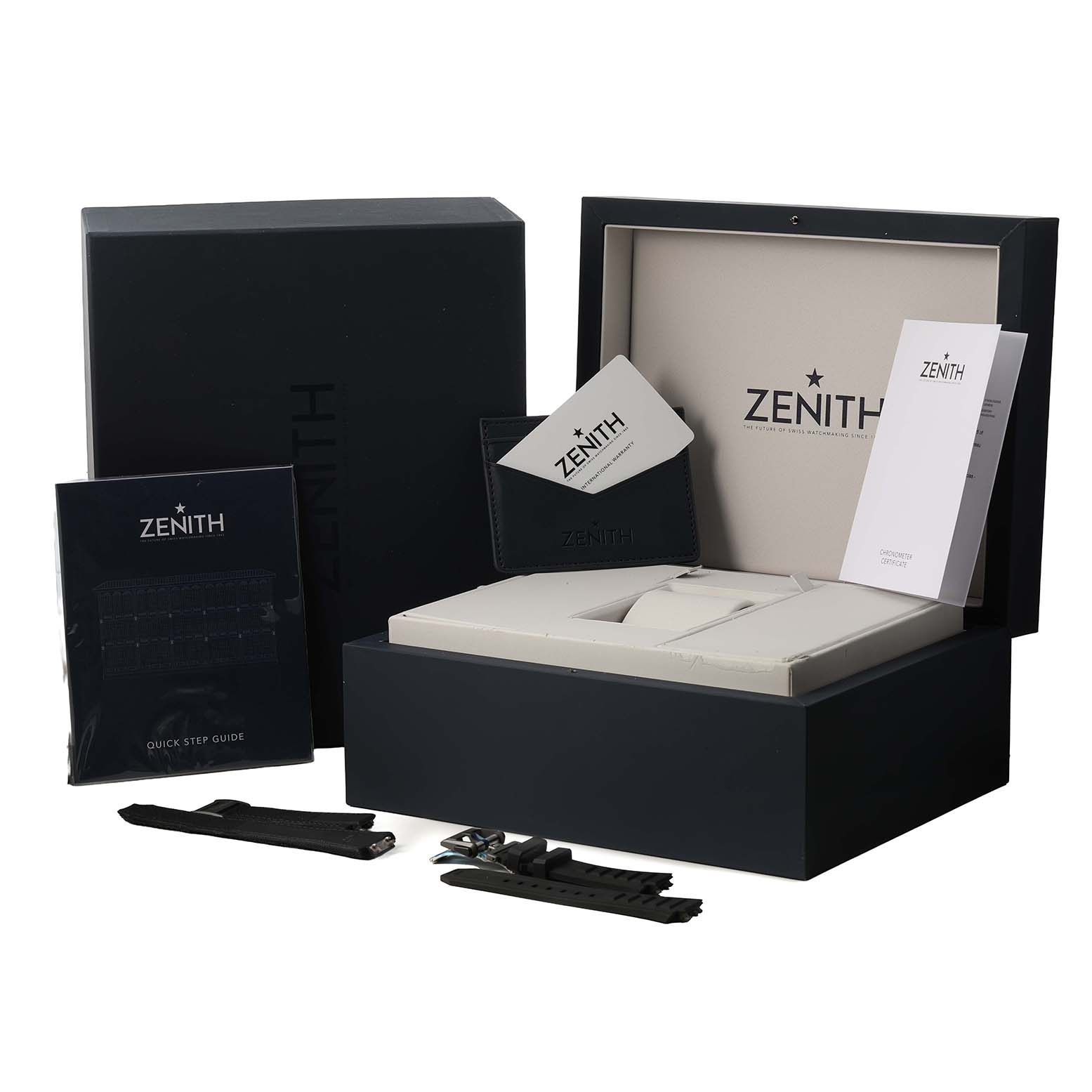 The image shows the Zenith Defy 87.9100.9004 Men's Titanium Grey Dial watch's packaging, including the box, warranty card, user guide, and additional straps.