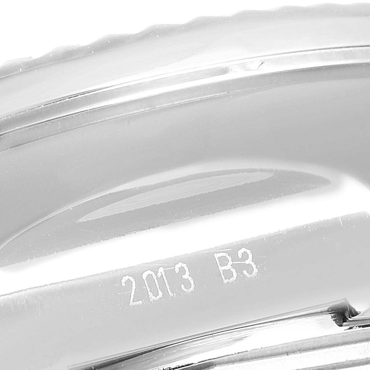 This image shows a close-up of the side of a Breitling Bentley AB0521U4/BC65 Men's Stainless Steel Black Dial AB0521U4/BC65 Men's Stainless Steel Black Dial watch case, featuring engraved markings "2013 B3."