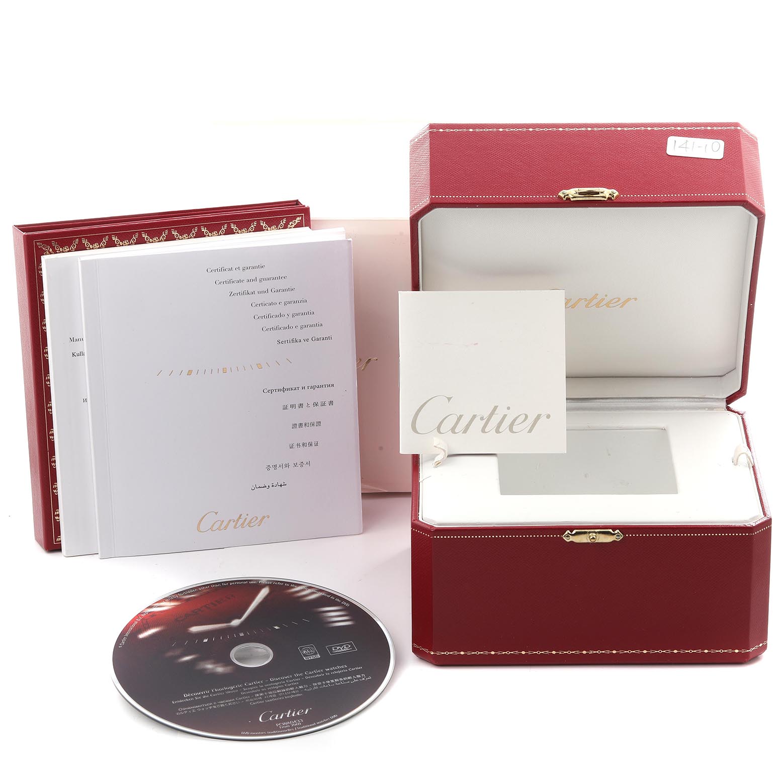 The image shows the packaging and accessories for the Calibre de Cartier watch, including a box, booklet, and DVD.