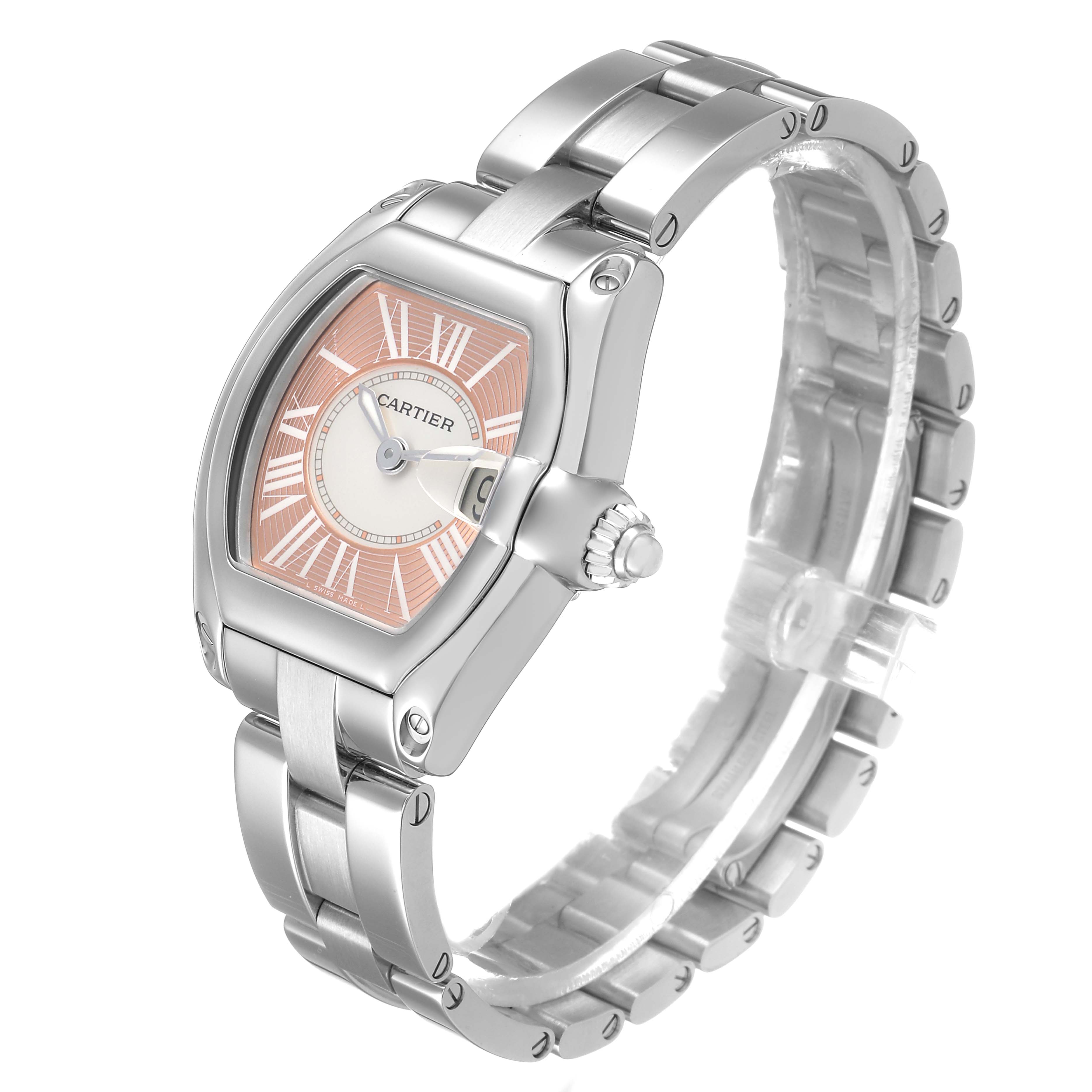 The Cartier Roadster W62017V3 Women's Stainless Steel Pink Dial watch is shown at a three-quarter angle, displaying the face, bezel, crown, and a portion of the bracelet.
