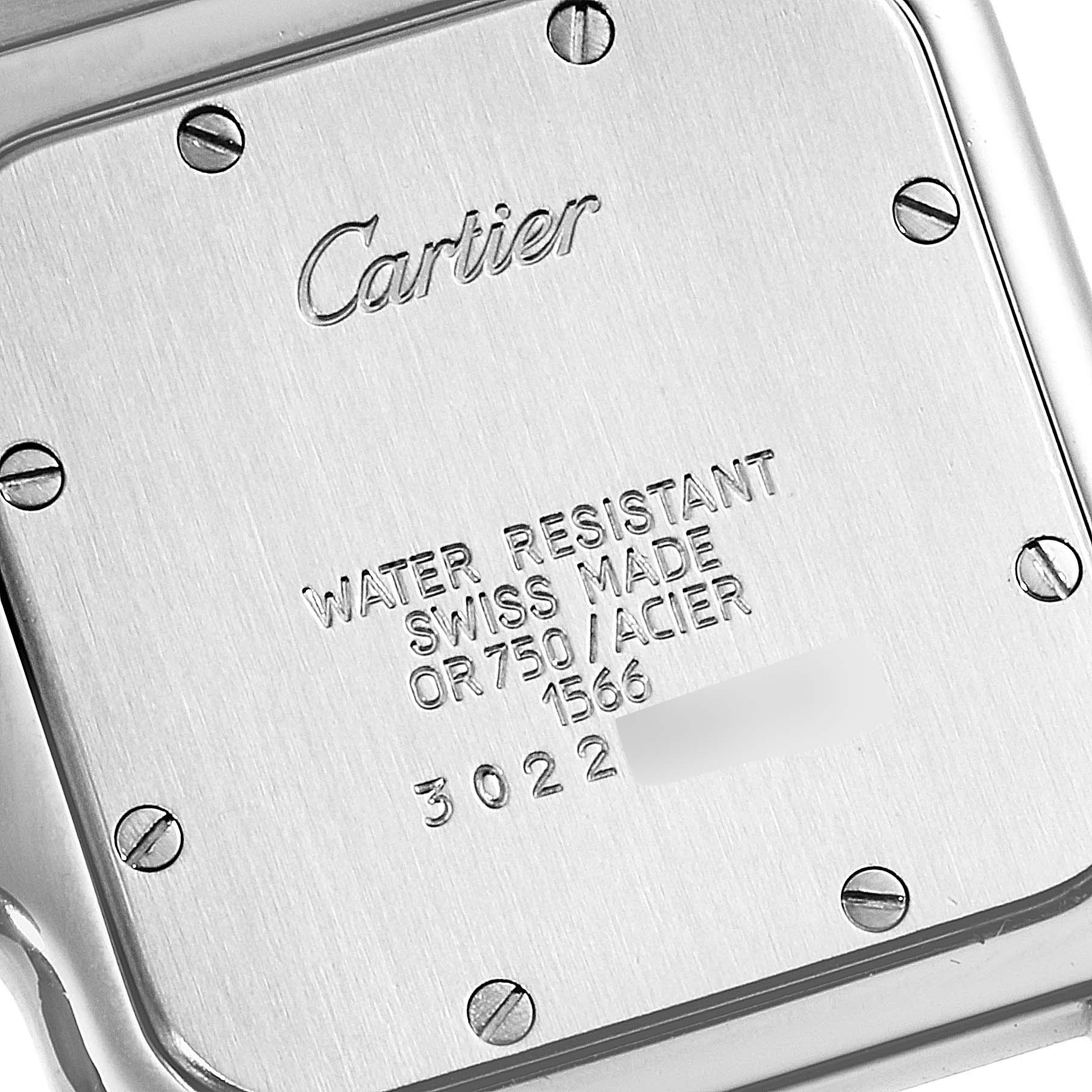 The image shows the backplate of a Santos model Cartier watch, highlighting its screws and engraved details.