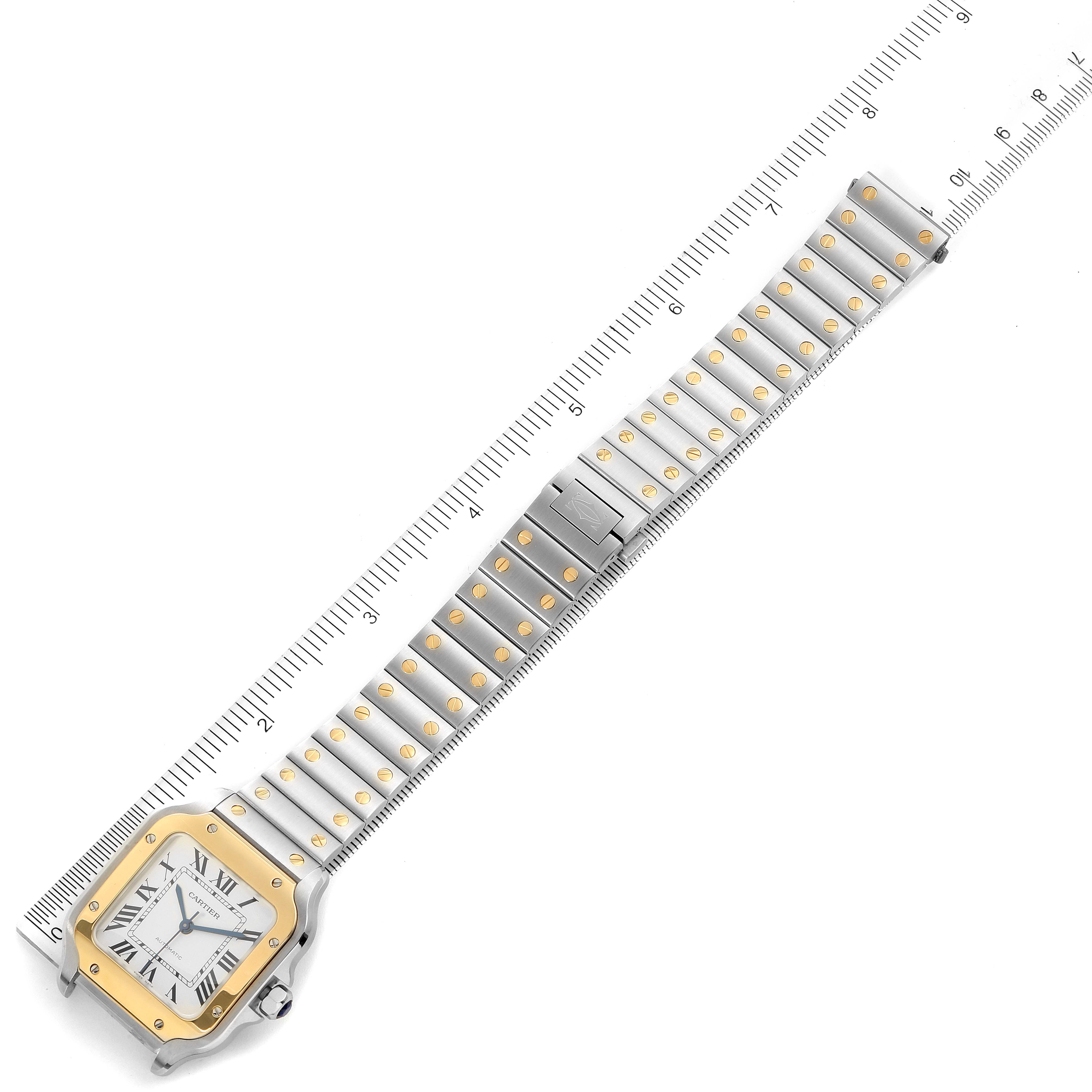 The image shows a top-down view of a Cartier Santos W2SA0007 Men
s Steel and Gold (two tone) Silver Dial W2SA0007 Men
s Steel and Gold (two tone) Silver Dial watch, highlighting the face, bezel, and bracelet with ruler measurements.