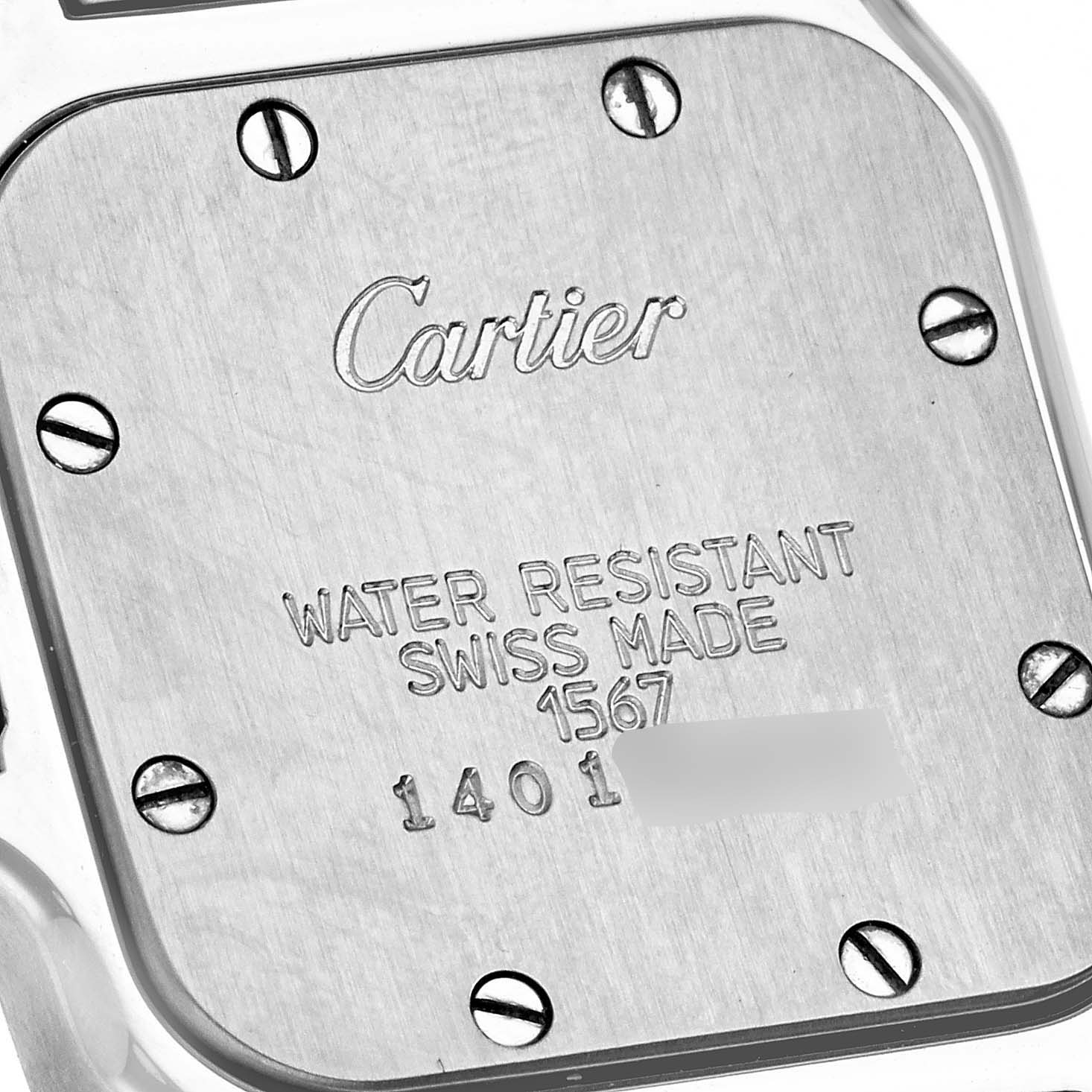 This image shows the back case of a Santos model watch by Cartier, featuring the brand's engraving and water resistance information.