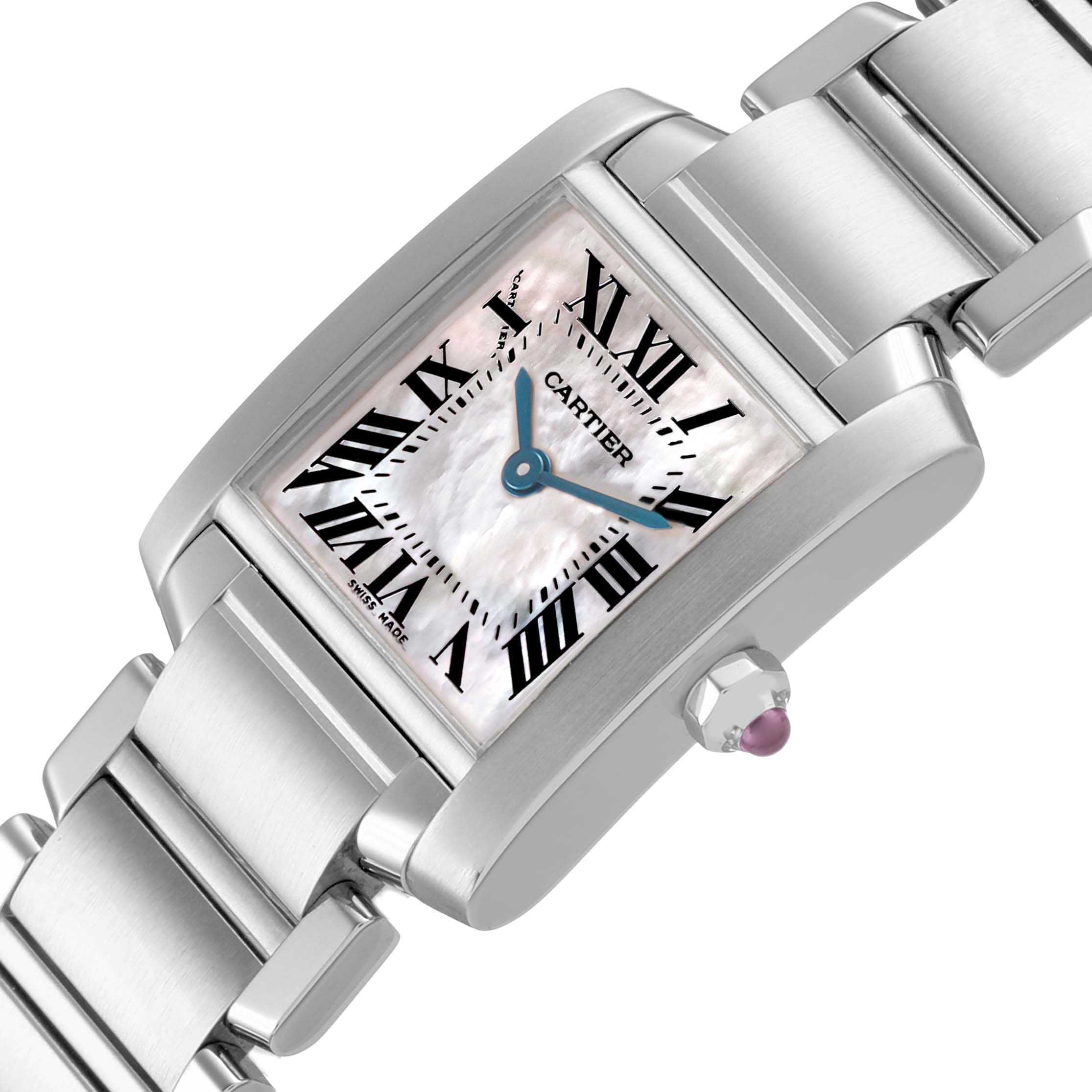 The Cartier Tank Française watch is shown at an angled view, highlighting its dial, Roman numerals, and metal bracelet with a crown featuring a cabochon.
