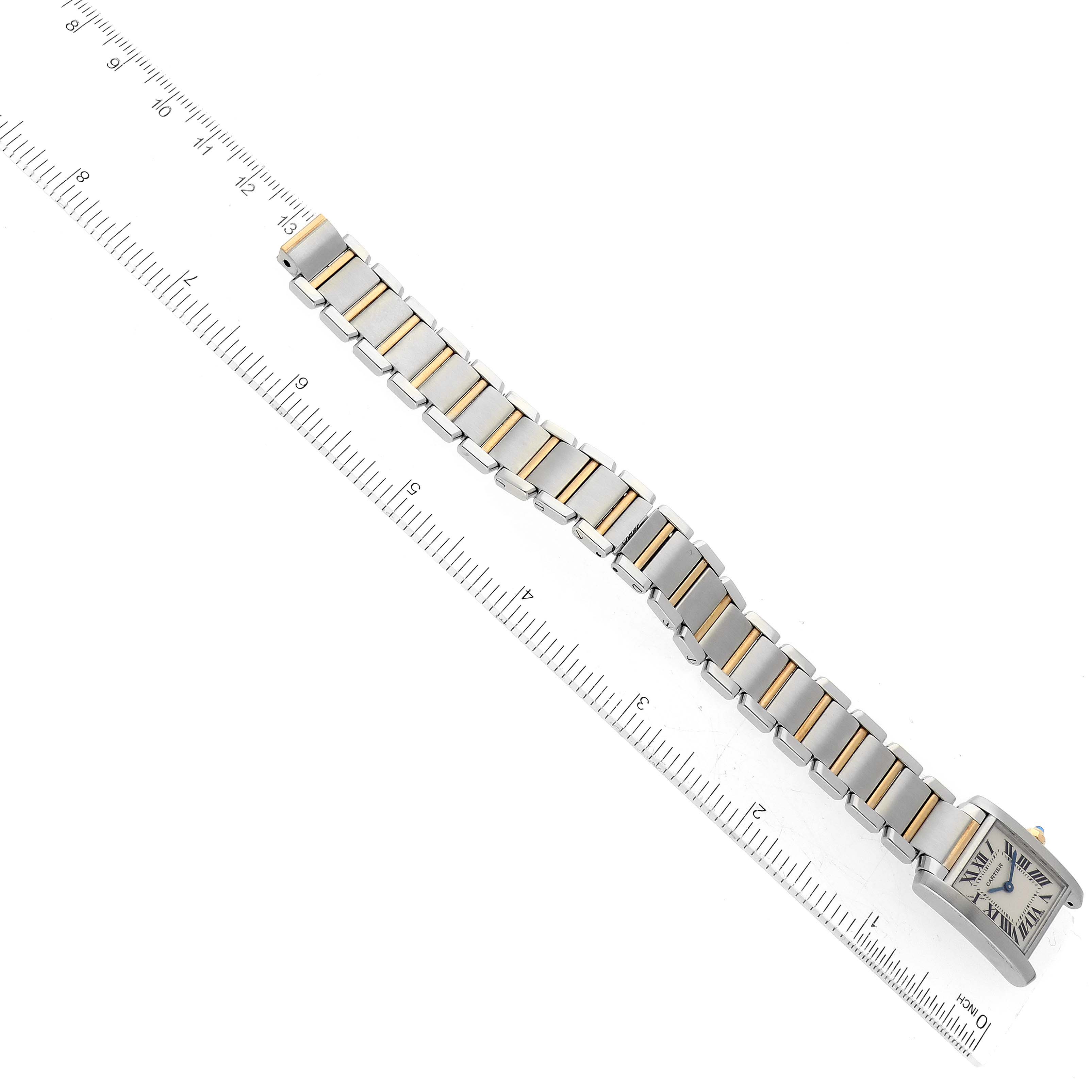 The image shows the full length of a Cartier Tank Francaise W51007Q4 Women's Stainless Steel Silver Dial W51007Q4 Women's Stainless Steel Silver Dial watch, including the bracelet and face, laid flat next to a ruler for scale.