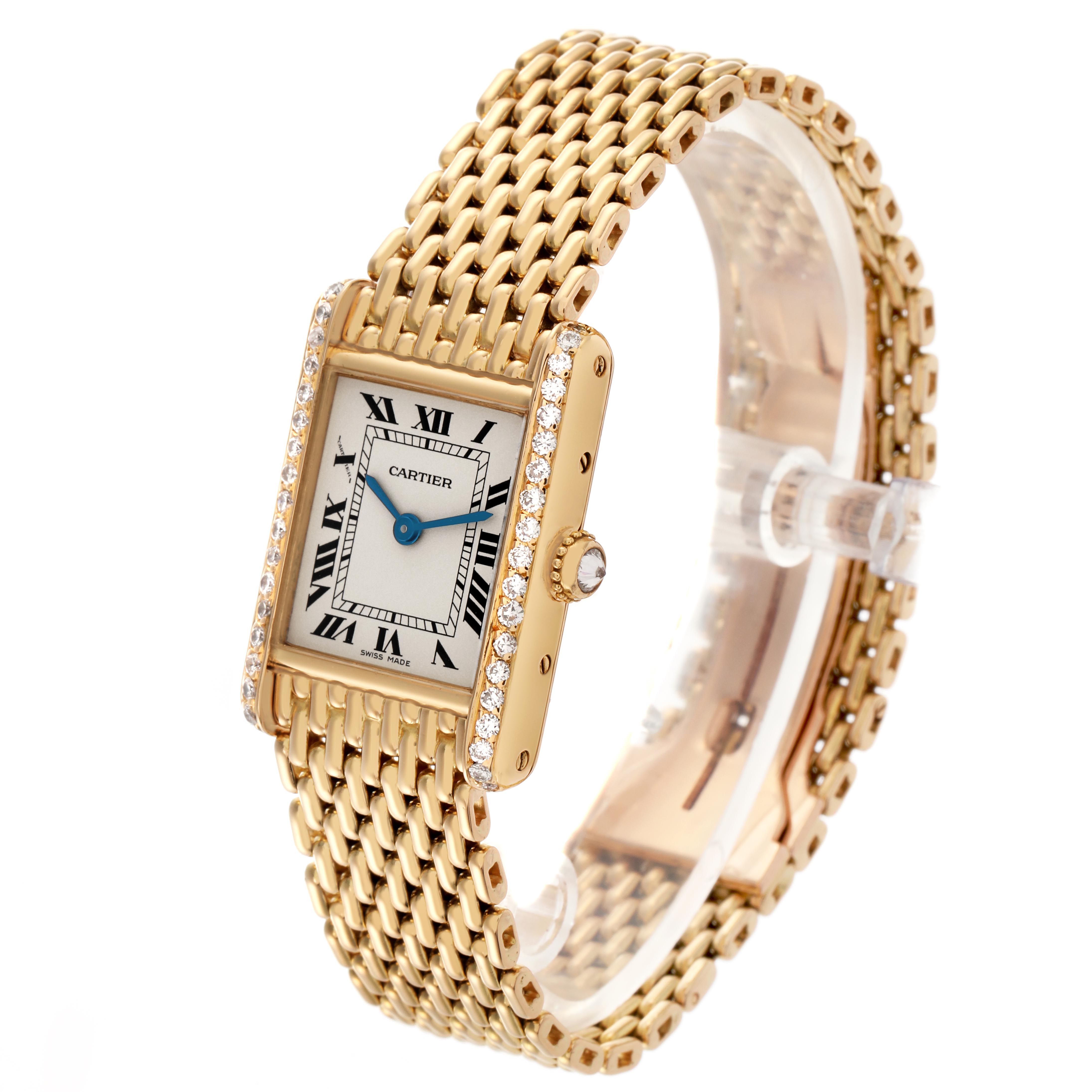 The Cartier Tank Louis WA2005C7 / 1150 Women's Yellow Gold White Dial WA2005C7 / 1150 Women's Yellow Gold White Dial watch is shown at a three-quarter angle, highlighting its face, diamond-set bezel, and gold bracelet.