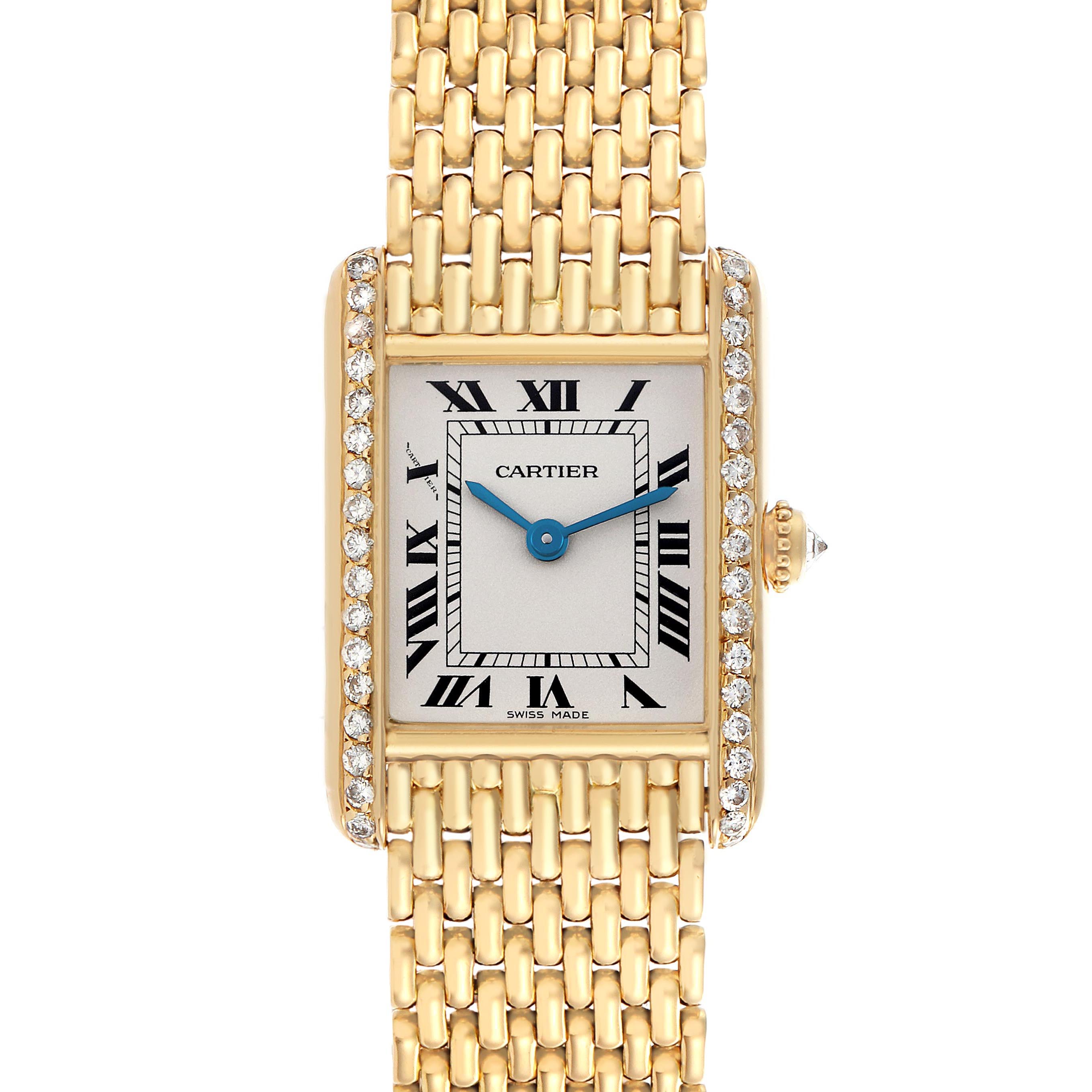 The Cartier Tank Louis WA2005C7 / 1150 Women's Yellow Gold White Dial WA2005C7 / 1150 Women's Yellow Gold White Dial watch is shown from the front, highlighting the face, Roman numerals, blue hands, diamond-adorned bezel, and gold bracelet.