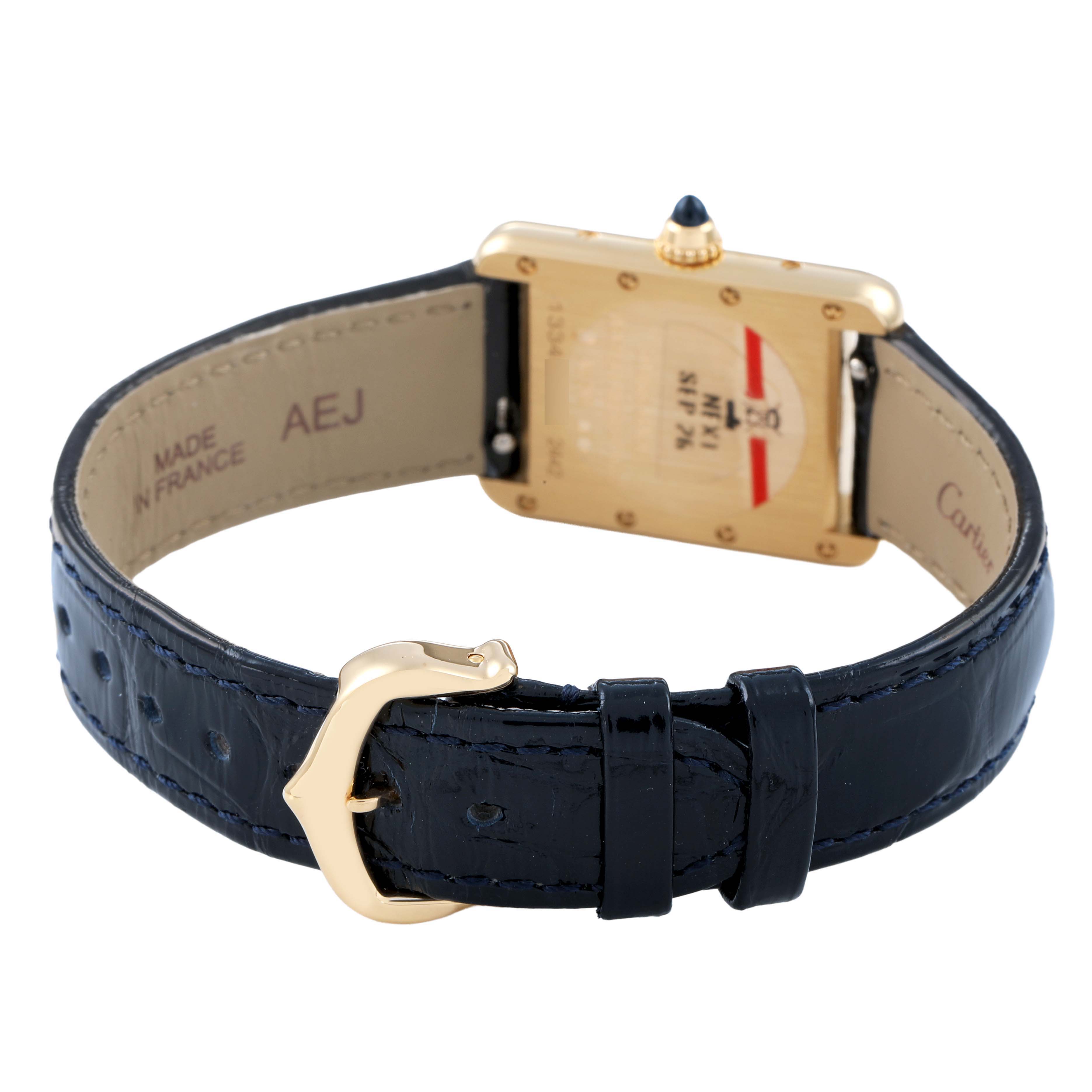 The Cartier Tank Louis WGTA0342 Women's Yellow Gold Silver Dial watch is shown from the back, highlighting its strap, buckle, and case back details.