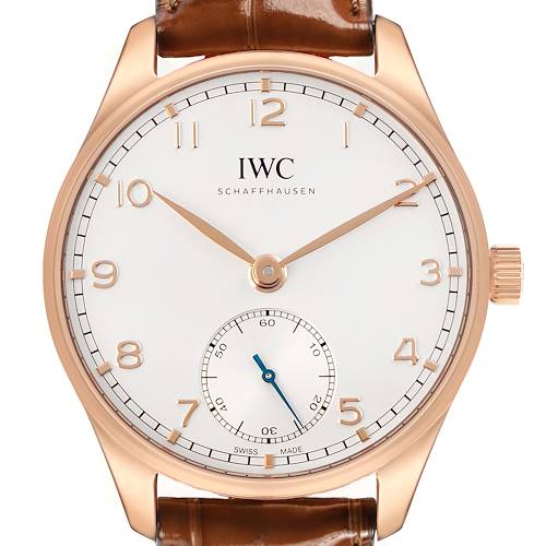 The IWC Portuguese IW358306 Men's Rose Gold Silver Dial watch is shown from the front, highlighting its dial, hands, numerals, and crown, with a leather strap.
