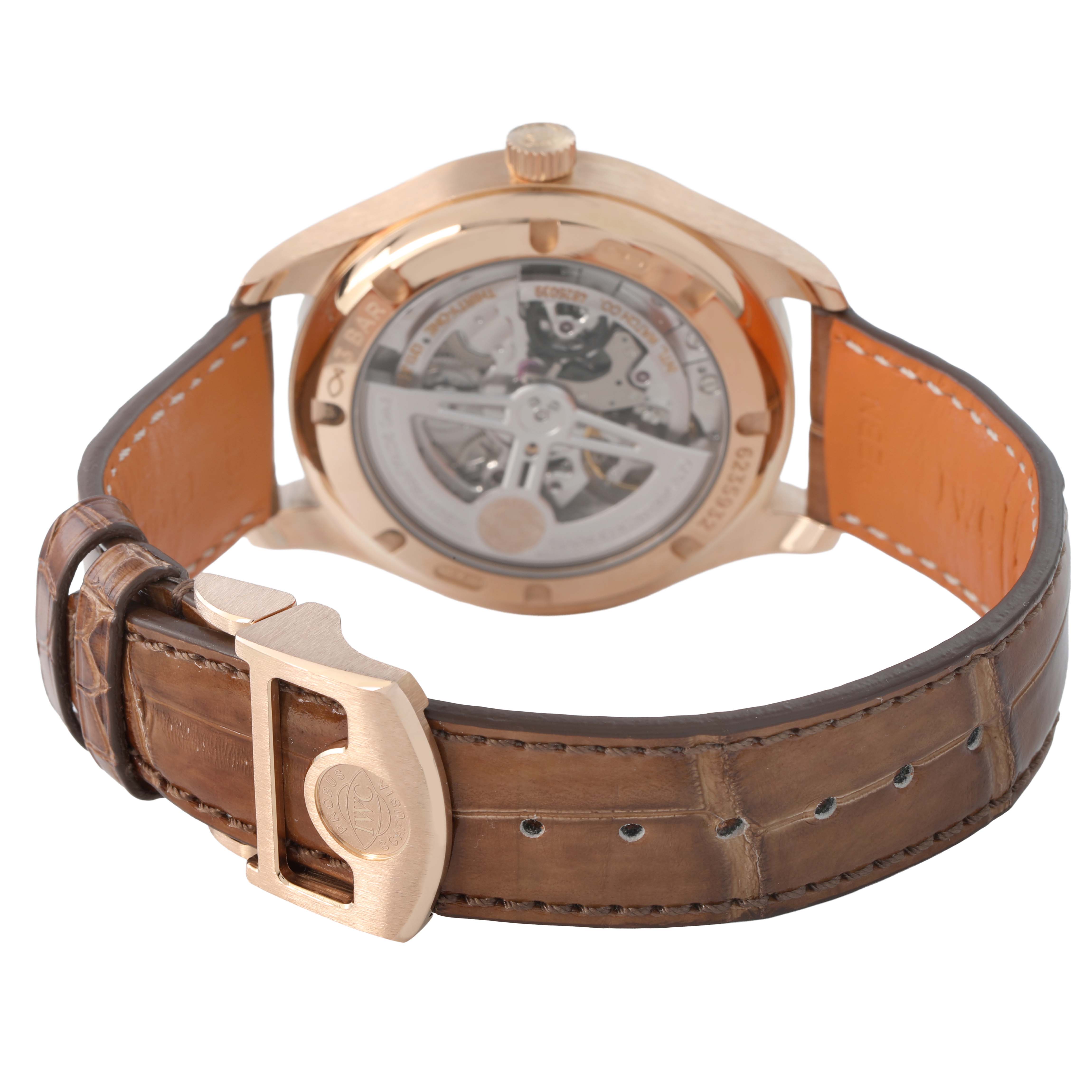 The IWC Portuguese IW358306 Men's Rose Gold Silver Dial watch is shown from the back, highlighting the movement and brown leather strap with a clasp.