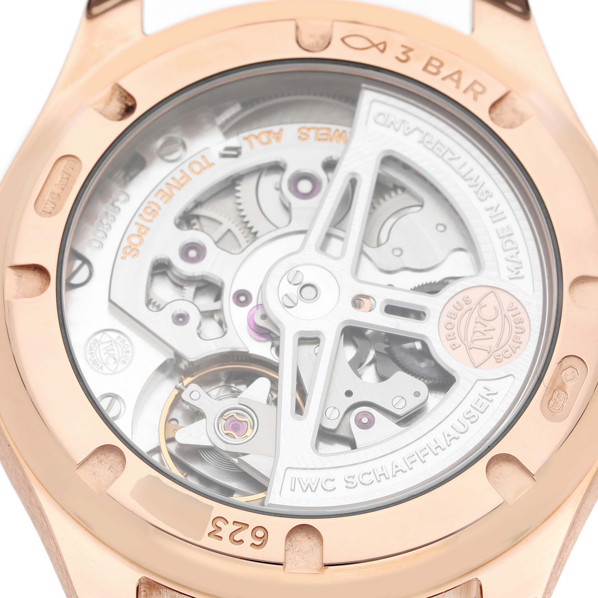 The image shows the back view of an IWC Portuguese IW358306 Men's Rose Gold Silver Dial watch, highlighting its intricate mechanical movement.