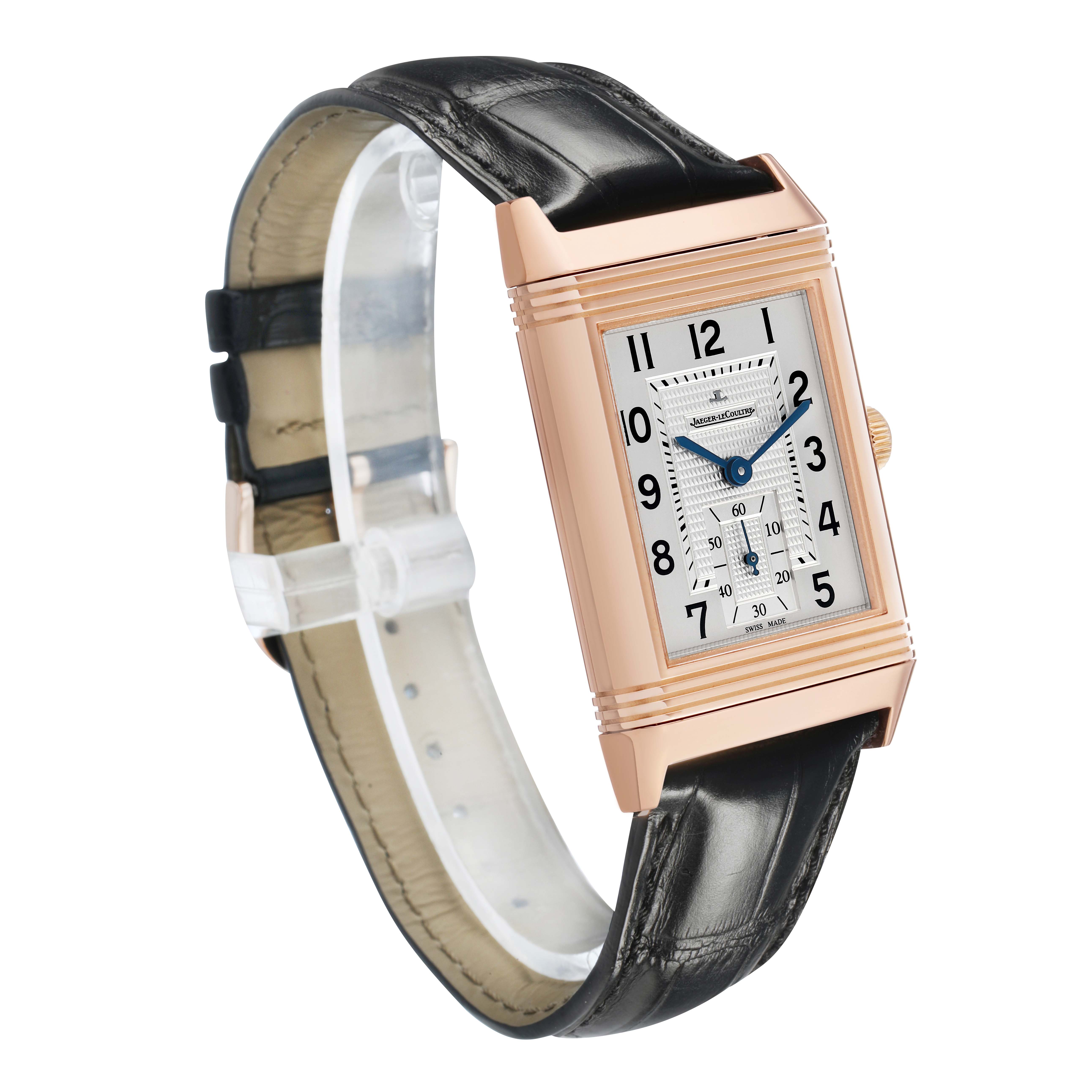 The Jaeger-LeCoultre Reverso watch is shown from an angled front view, highlighting its rectangular face and leather strap.