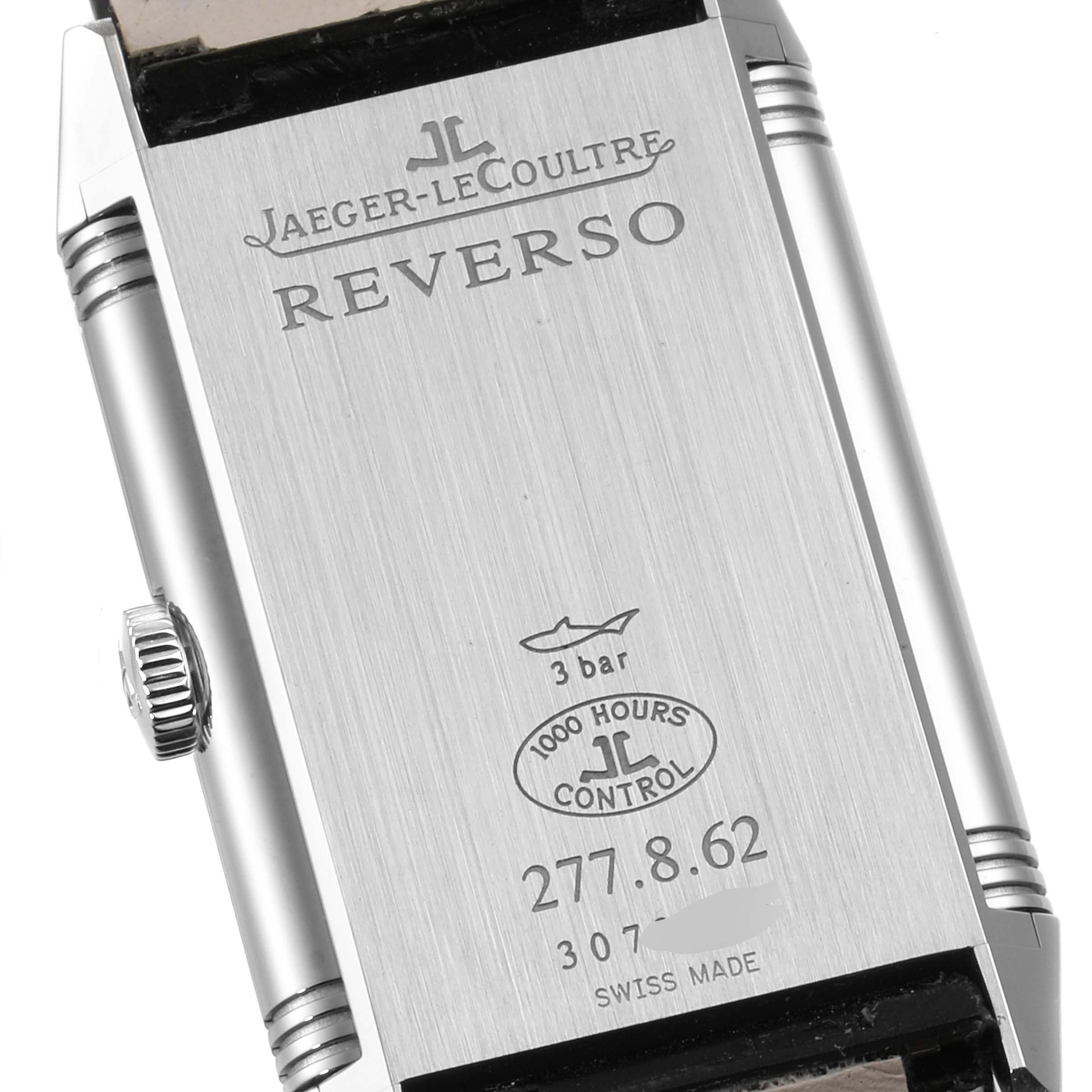 The image shows the back case of a Jaeger-LeCoultre Reverso watch, displaying brand markings, model details, and water resistance.