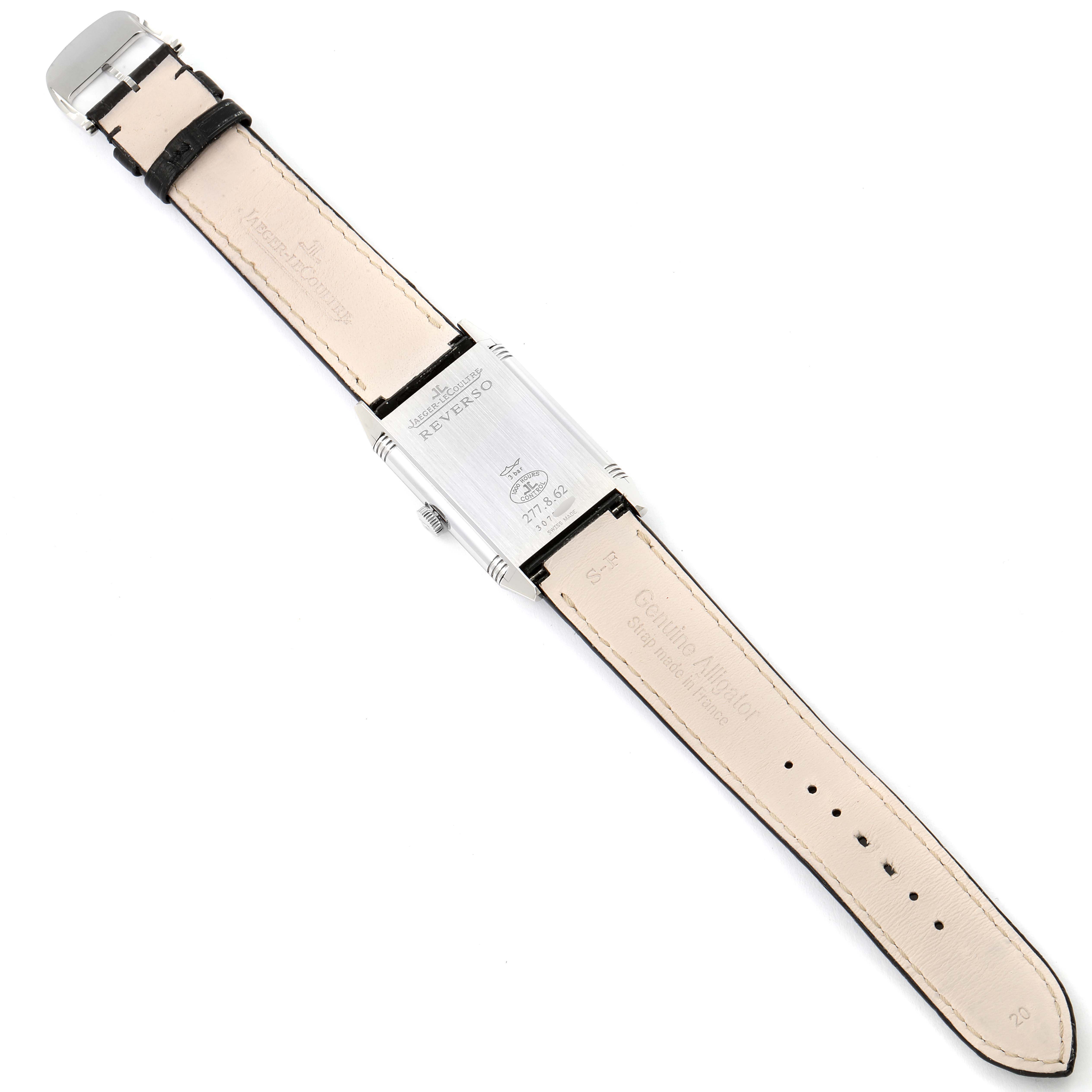 The image shows the back of a Jaeger-LeCoultre Reverso watch with its leather strap fully extended.