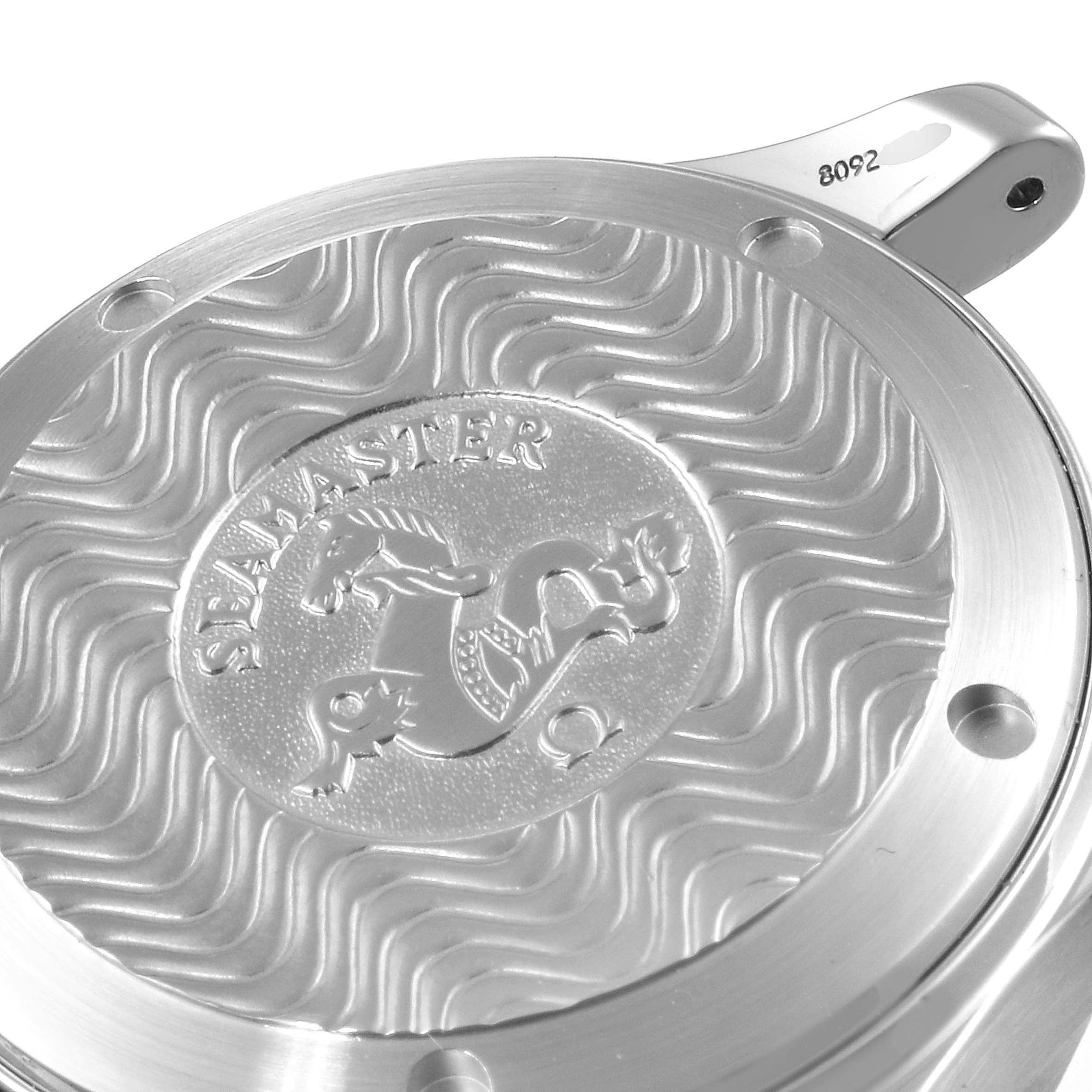 The image shows a close-up of the Omega Seamaster 2253.80.00 Men
s Stainless Steel Blue Dial 2253.80.00 Men
s Stainless Steel Blue Dial
s case back, featuring its emblem and wave pattern design.