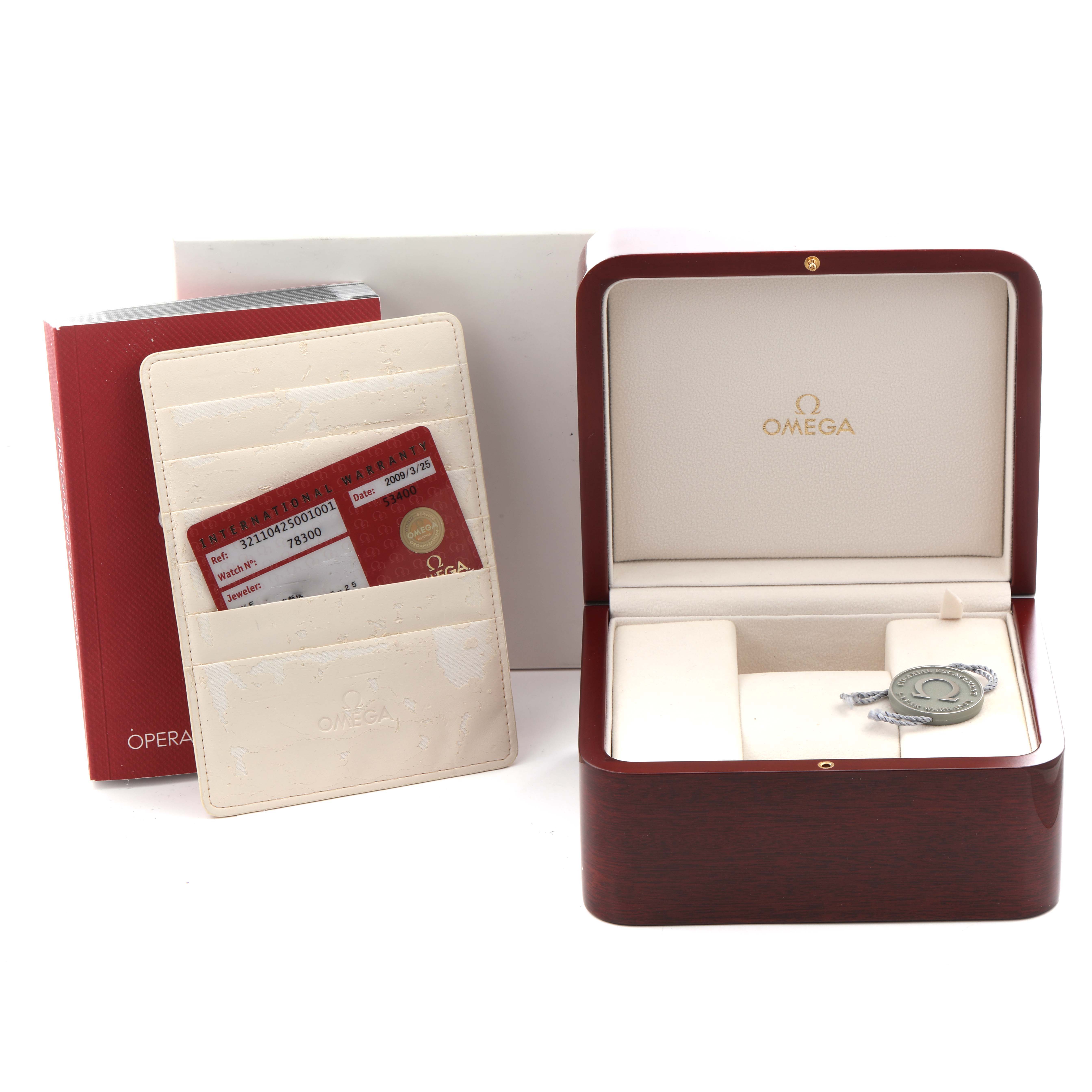 The image shows an open Omega Speedmaster 321.10.42.50.01.001 Men
s Stainless Steel Black Dial 321.10.42.50.01.001 Men
s Stainless Steel Black Dial watch box, warranty cards, and a branded booklet.