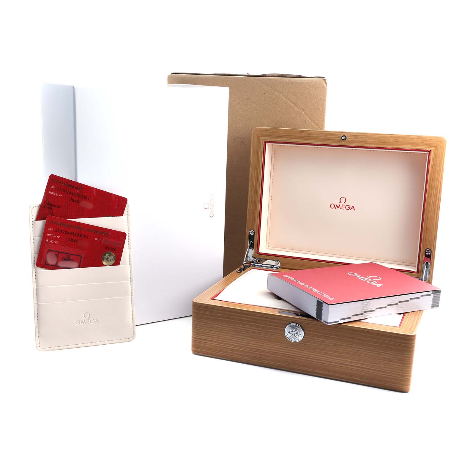 The image shows a wooden Omega Speedmaster 321.92.44.52.01.001 Men's Titanium Black Dial watch box, documentation, and cards, viewed from the side.