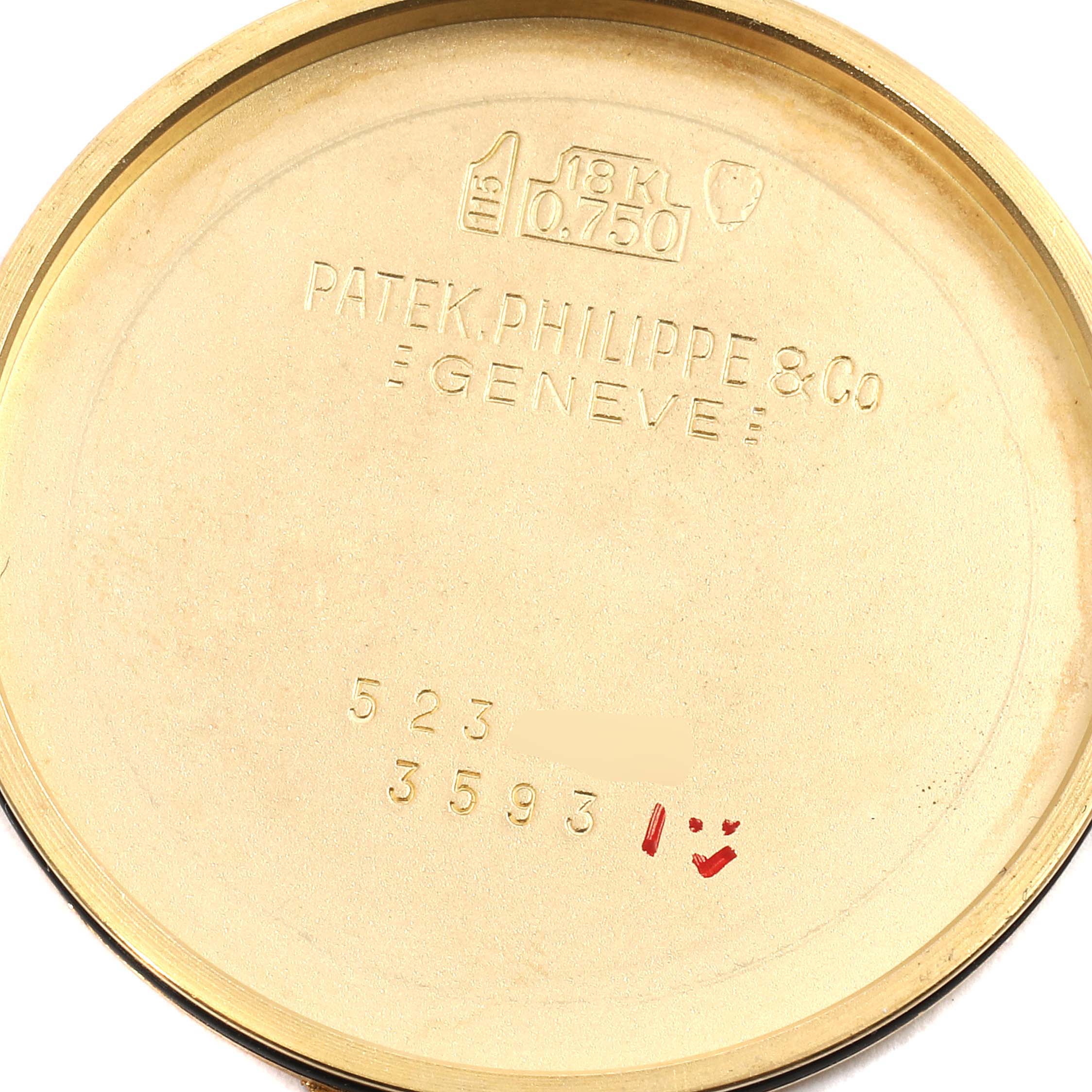 This is an inside view of the Vintage Patek Philippe watch case back, showing engravings and hallmarks.