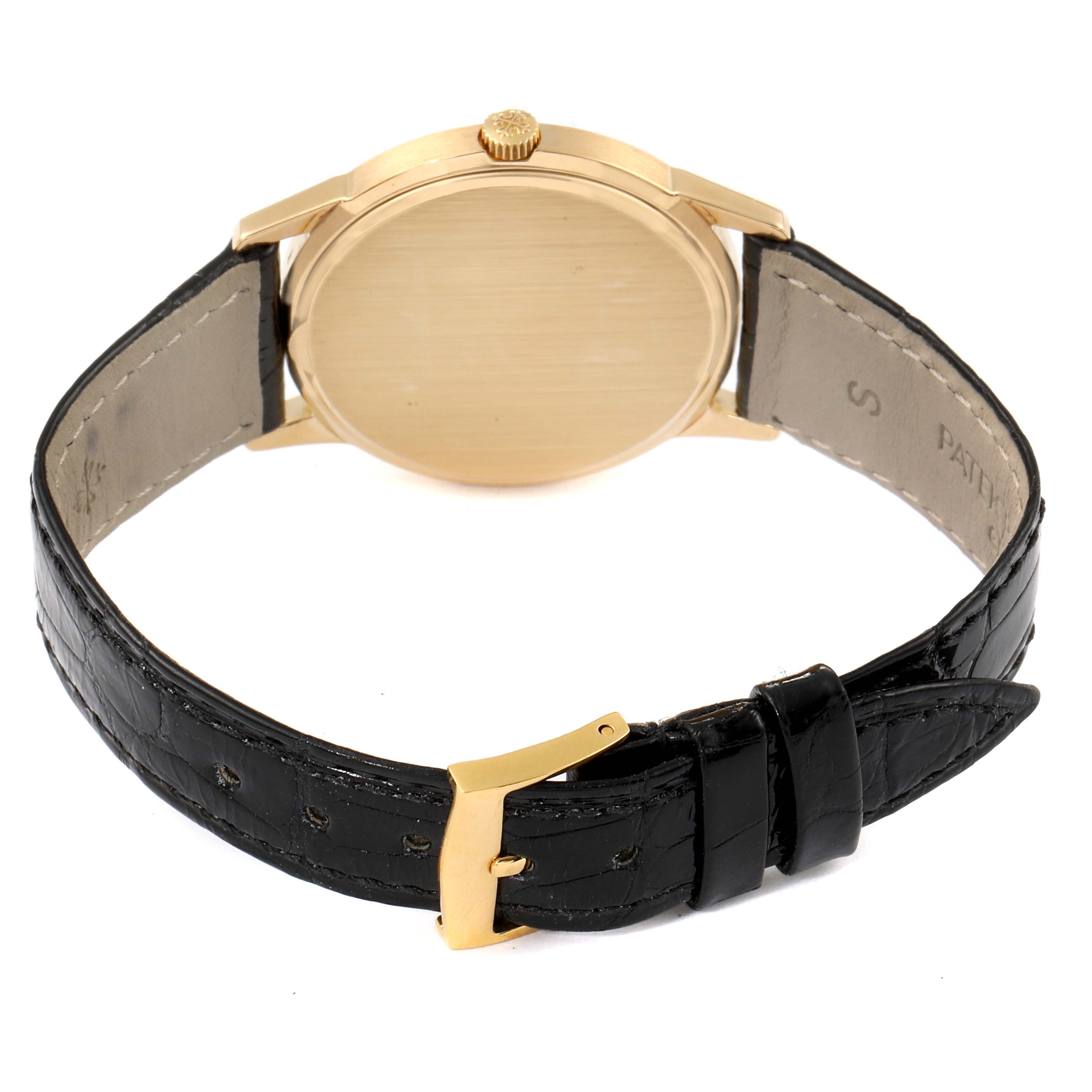 The image shows the back view of a Patek Philippe Vintage model watch with a leather strap and gold buckle.