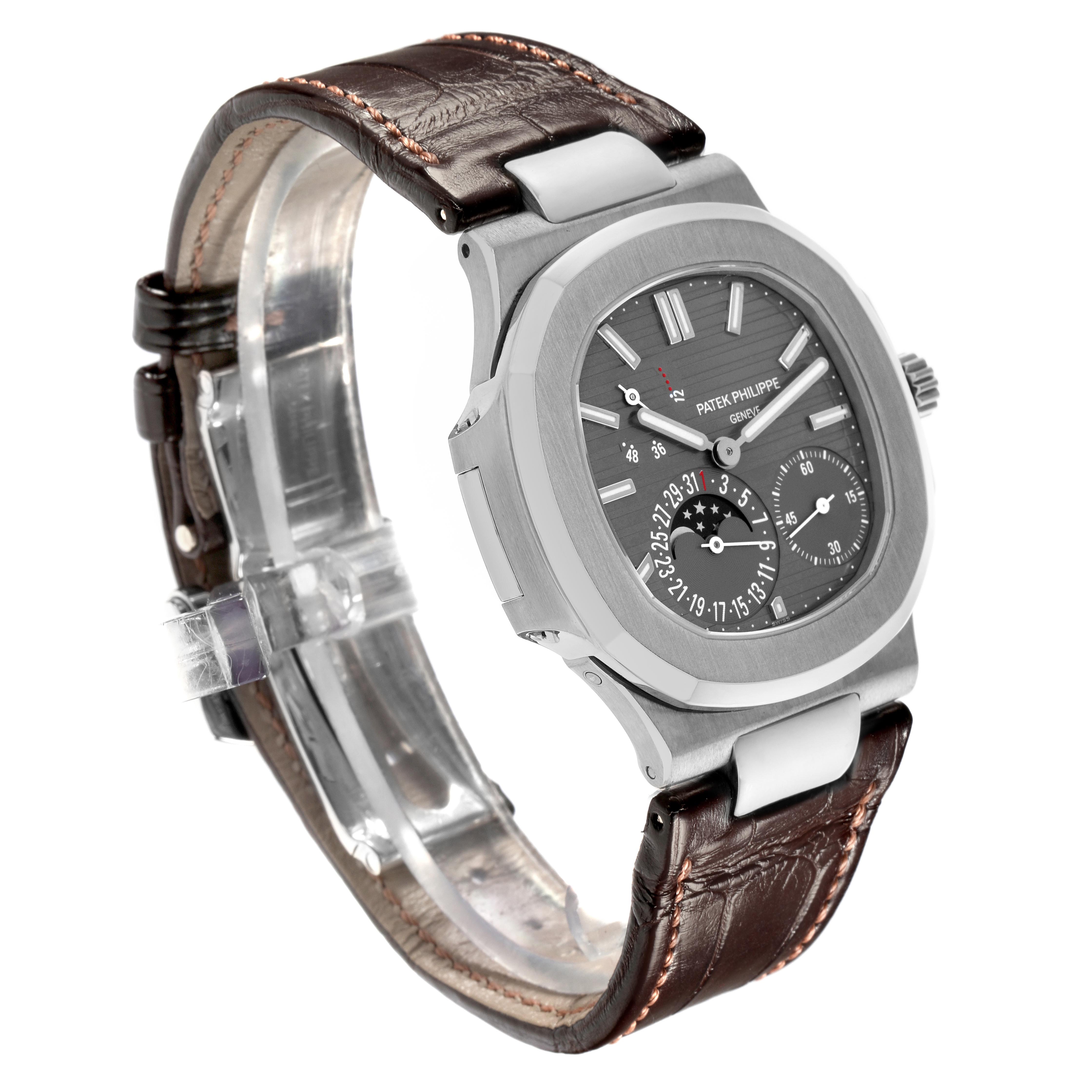 The Patek Philippe Nautilus 5712G-001 Men's White Gold Grey Dial 5712G-001 Men's White Gold Grey Dial watch is shown at a three-quarter angle, highlighting its face, leather strap, and side profile.