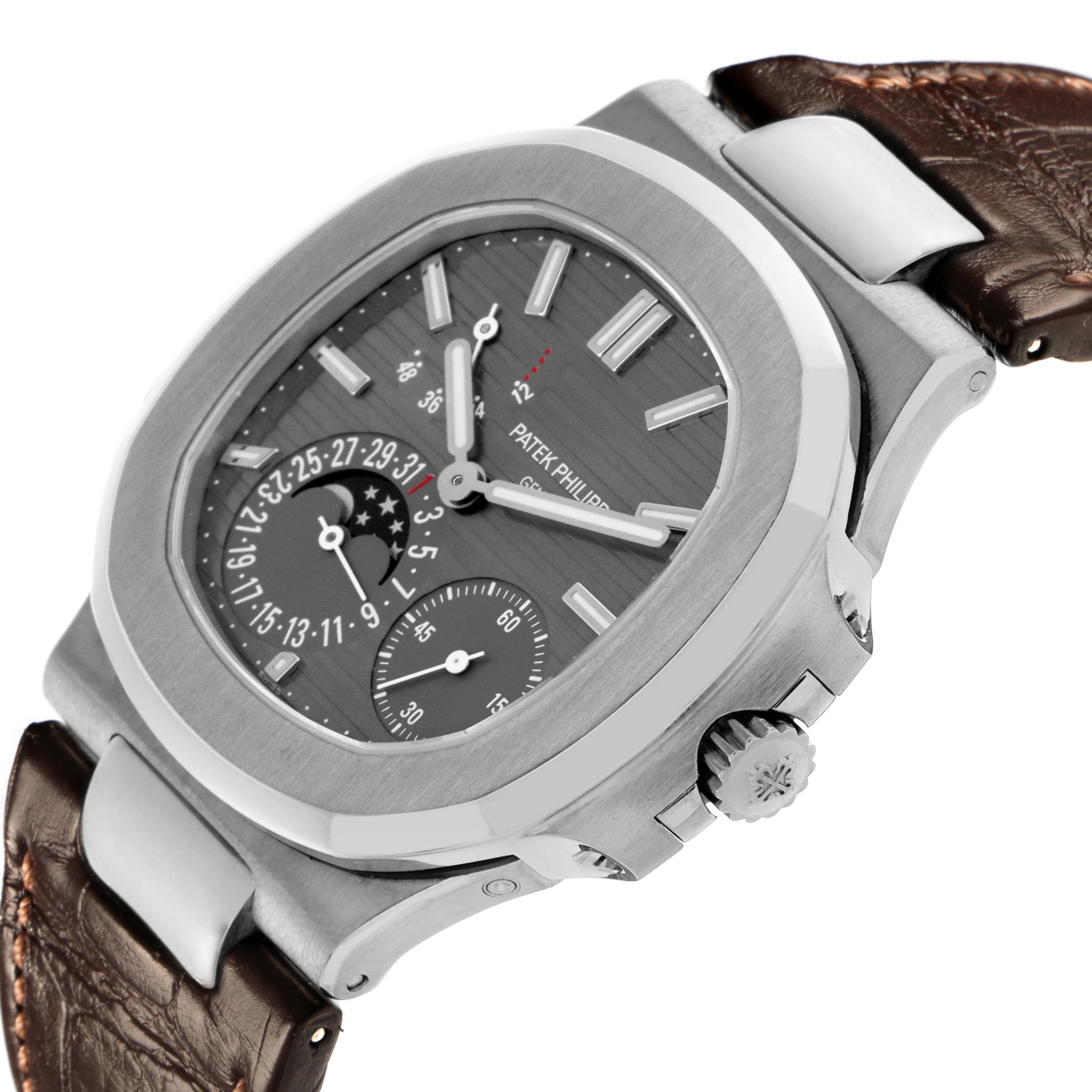 The image shows a Patek Philippe Nautilus 5712G-001 Men's White Gold Grey Dial 5712G-001 Men's White Gold Grey Dial watch at a side angle, highlighting the crown, case, and dial details with leather strap.