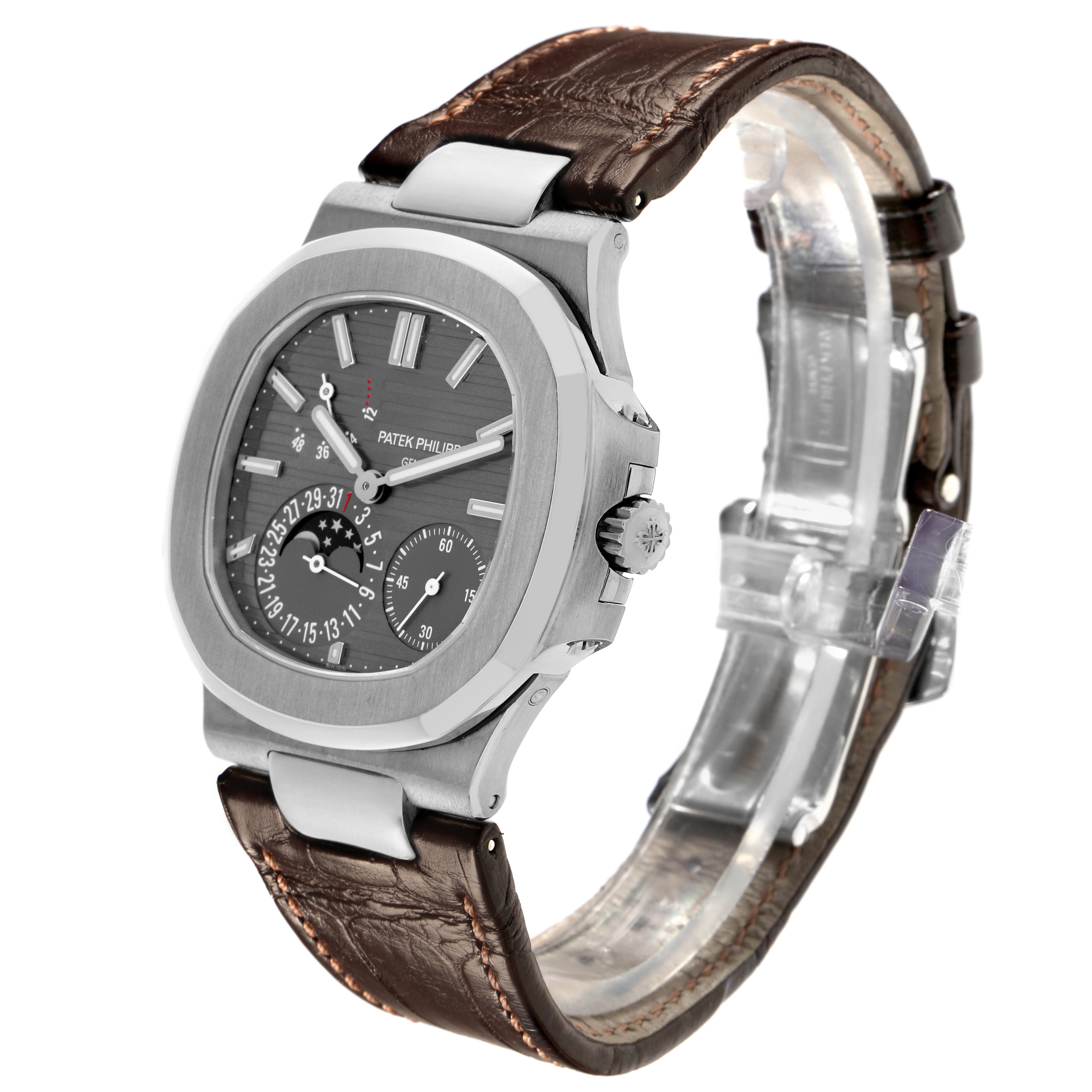 The Patek Philippe Nautilus 5712G-001 Men's White Gold Grey Dial 5712G-001 Men's White Gold Grey Dial watch is shown at a three-quarter angle, displaying the face, case, crown, and leather strap.