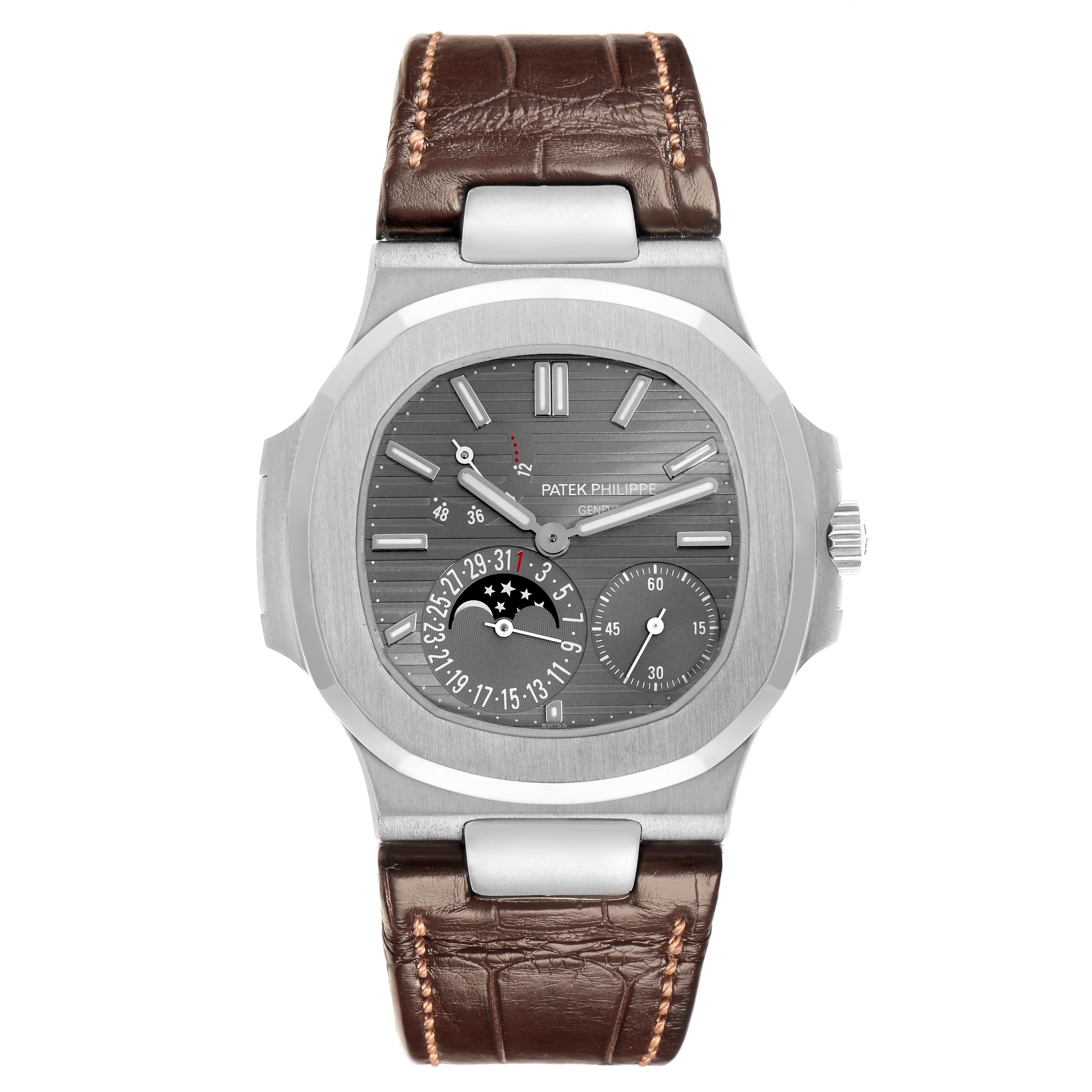 The Patek Philippe Nautilus 5712G-001 Men's White Gold Grey Dial 5712G-001 Men's White Gold Grey Dial watch is shown from a front angle, displaying the face, dial features, and brown leather strap.