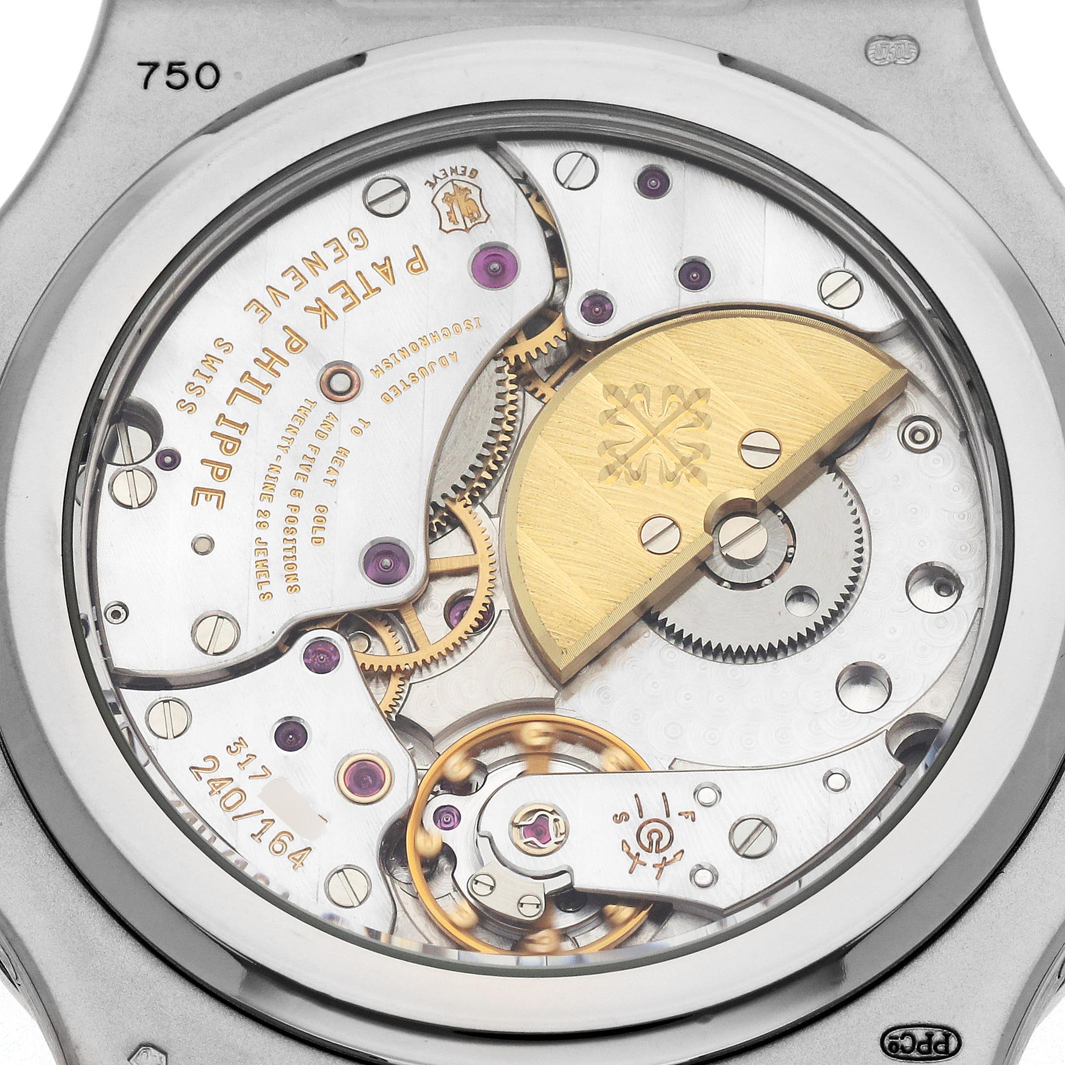 The image shows the movement of a Patek Philippe Nautilus 5712G-001 Men's White Gold Grey Dial 5712G-001 Men's White Gold Grey Dial, highlighting its rotor and intricate mechanical components from the back.