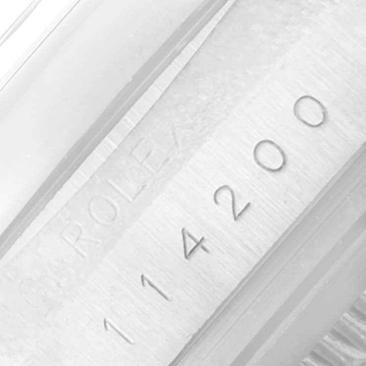 This image shows a close-up of the Rolex Air-King 114200 Men's Stainless Steel Silver Dial 114200 Men's Stainless Steel Silver Dial model, focusing on the watch's engraved case back with the model number "114200."