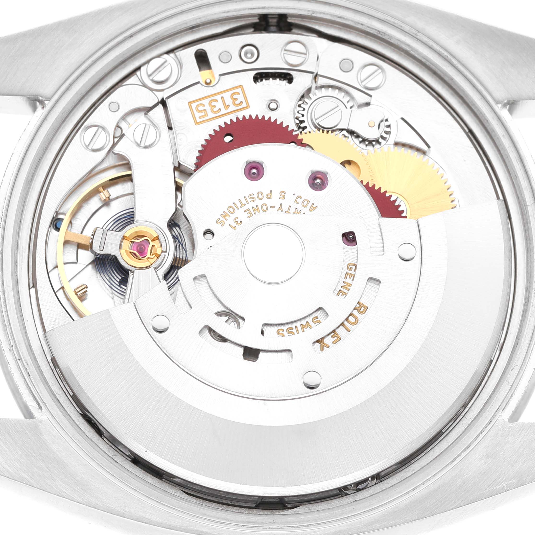 The image shows a detailed view of the movement inside a Rolex Date 115200 Men's Stainless Steel Blue Dial watch, highlighting gears and mechanical components.