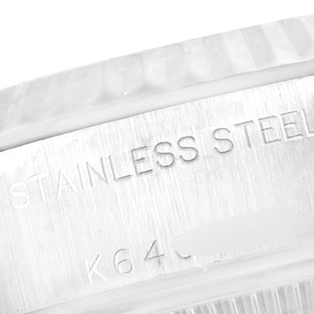 The image shows a close-up of the stainless steel casing with engraved details of a Rolex Datejust 79174 Women's Stainless Steel Blue Dial 79174 Women's Stainless Steel Blue Dial watch.