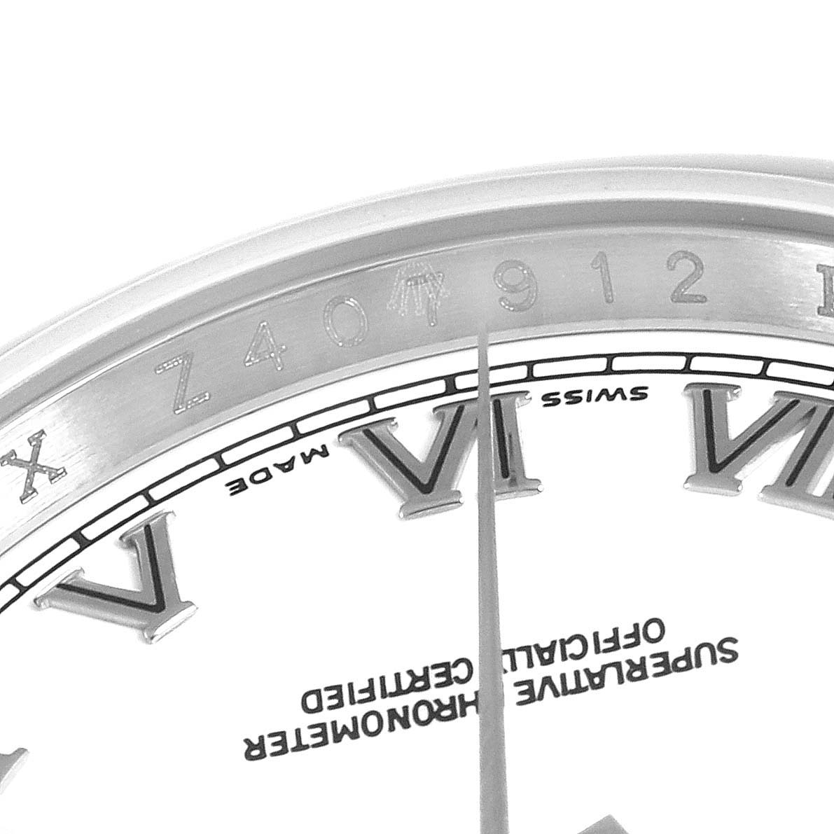The image shows a close-up view of the Rolex Datejust 116200 Men's Stainless Steel White Dial 116200 Men's Stainless Steel White Dial watch's dial and part of the bezel, featuring Roman numerals.