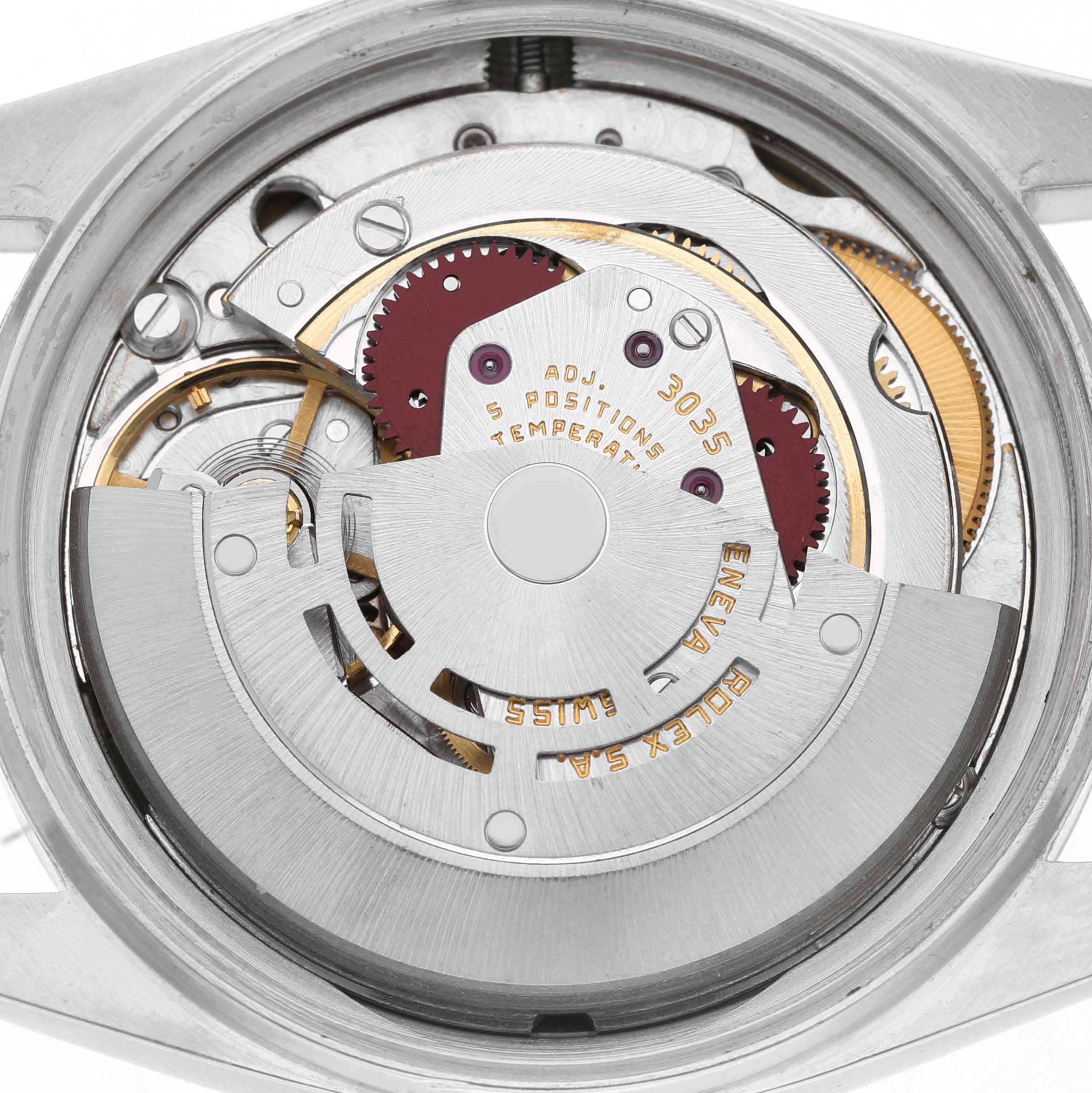 The image shows the intricate movement of a Rolex Datejust 16013 Men's Steel and Gold (two tone) White Dial watch, viewed from the back, highlighting gears and rotors.