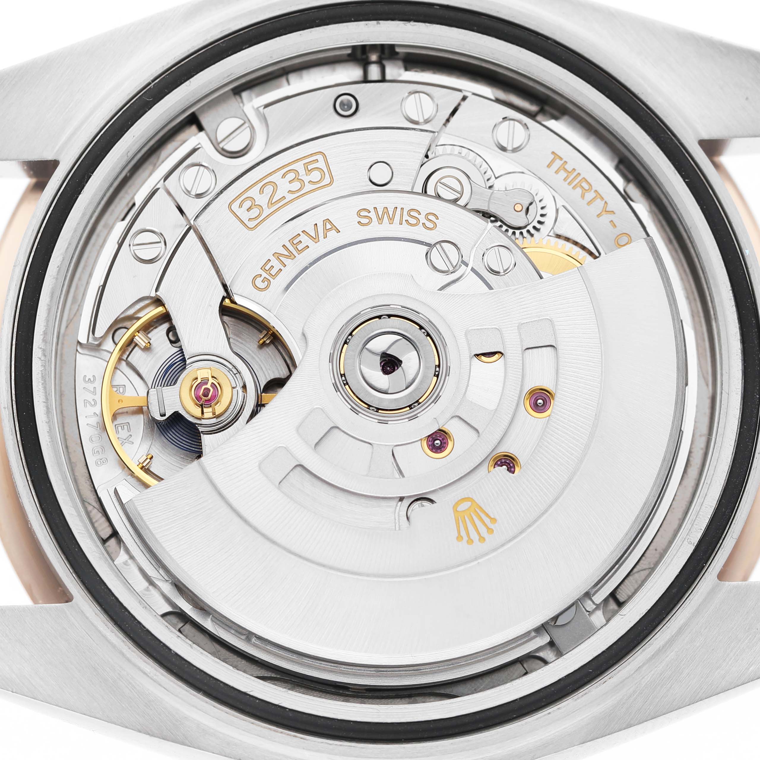 The image shows the movement of a Rolex Datejust 41 126331 Men's Steel and Gold (two tone) Grey Dial from a back angle, highlighting the rotor and intricate mechanisms.