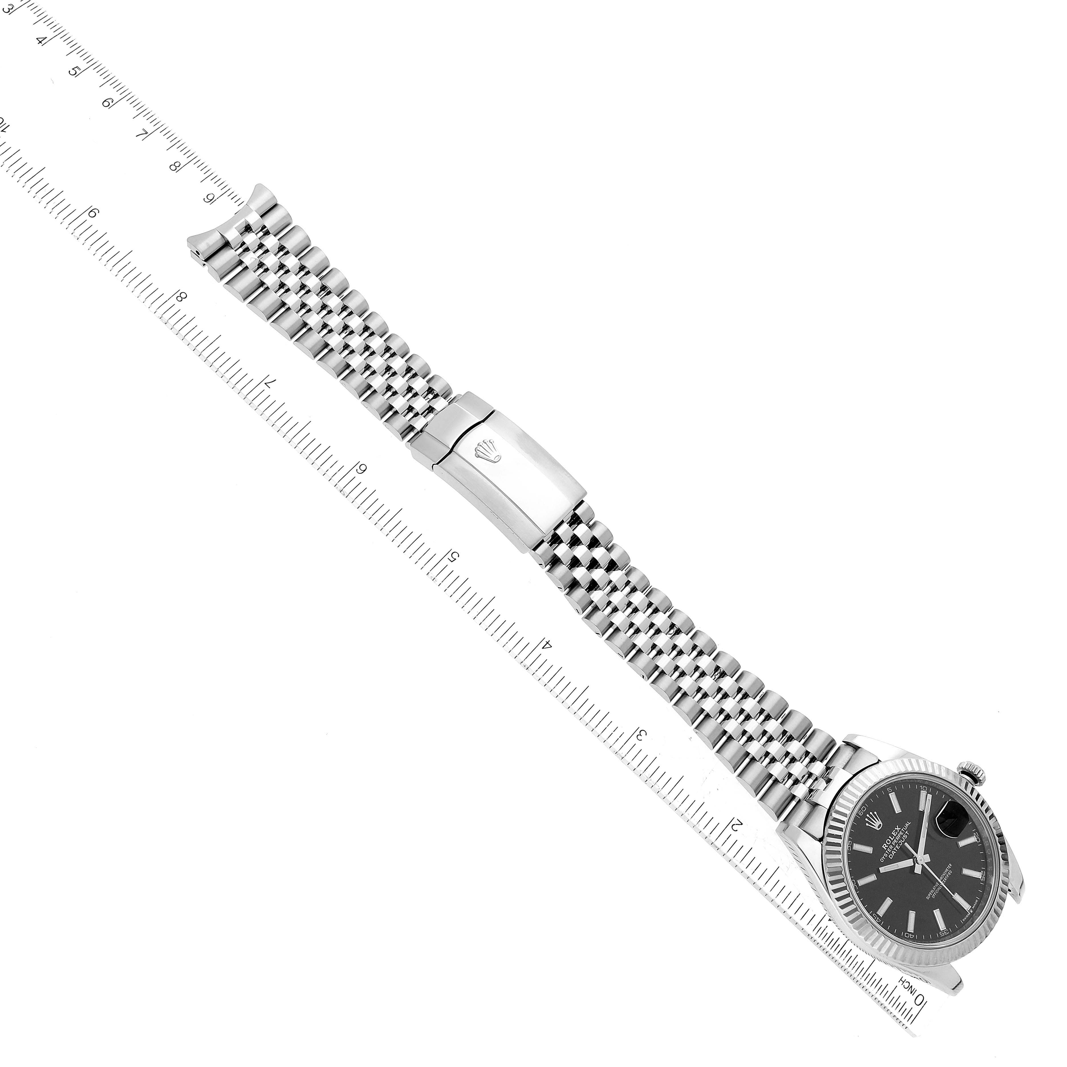The image shows the Rolex Datejust 41 126334 Men
s Stainless Steel Black Dial 126334 Men
s Stainless Steel Black Dial watch laid flat with its bracelet extended, alongside a ruler for measurement.