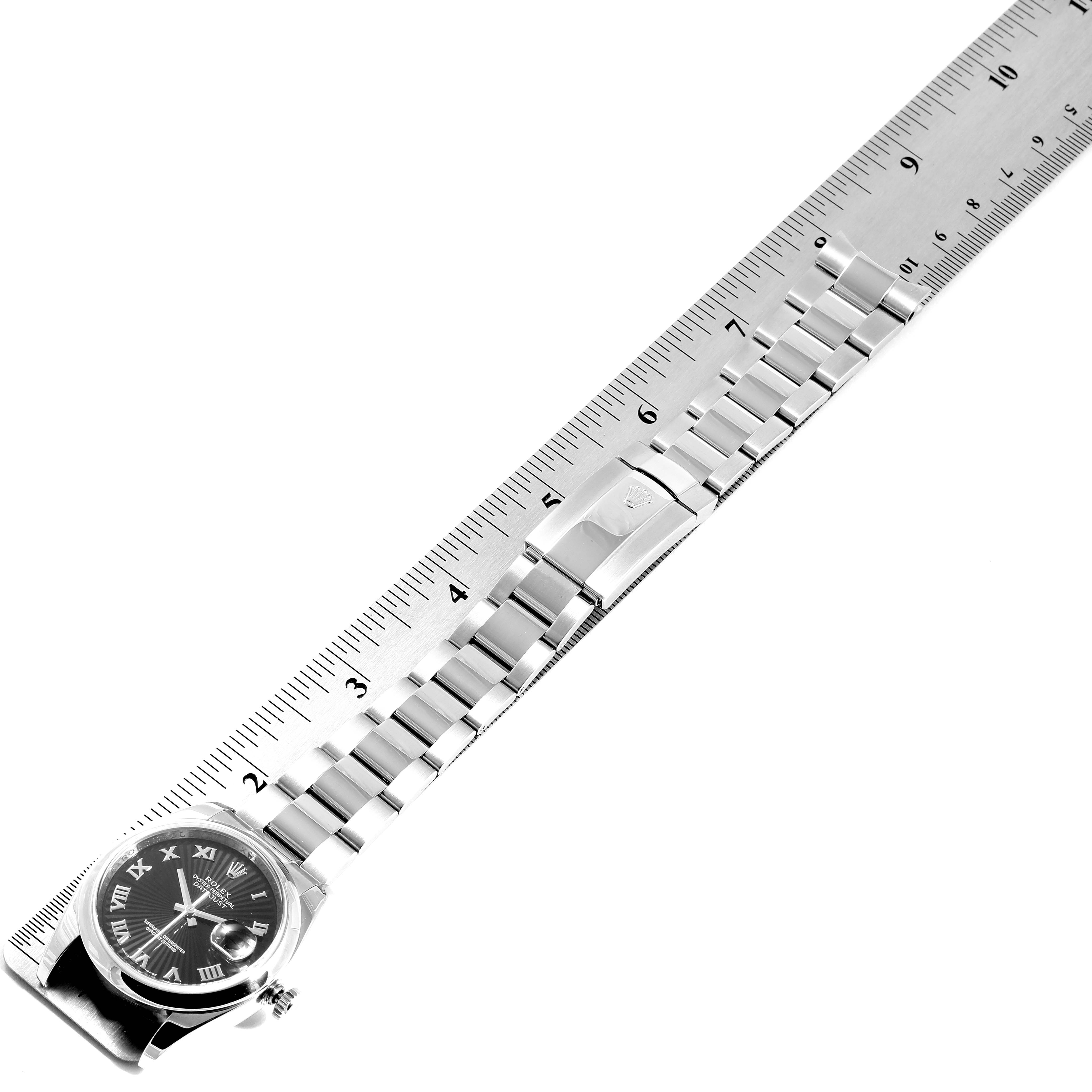 The image shows a Rolex Datejust 116200 Men's Stainless Steel Black Dial 116200 Men's Stainless Steel Black Dial watch laid flat next to a ruler, displaying its face, bracelet, and clasp.