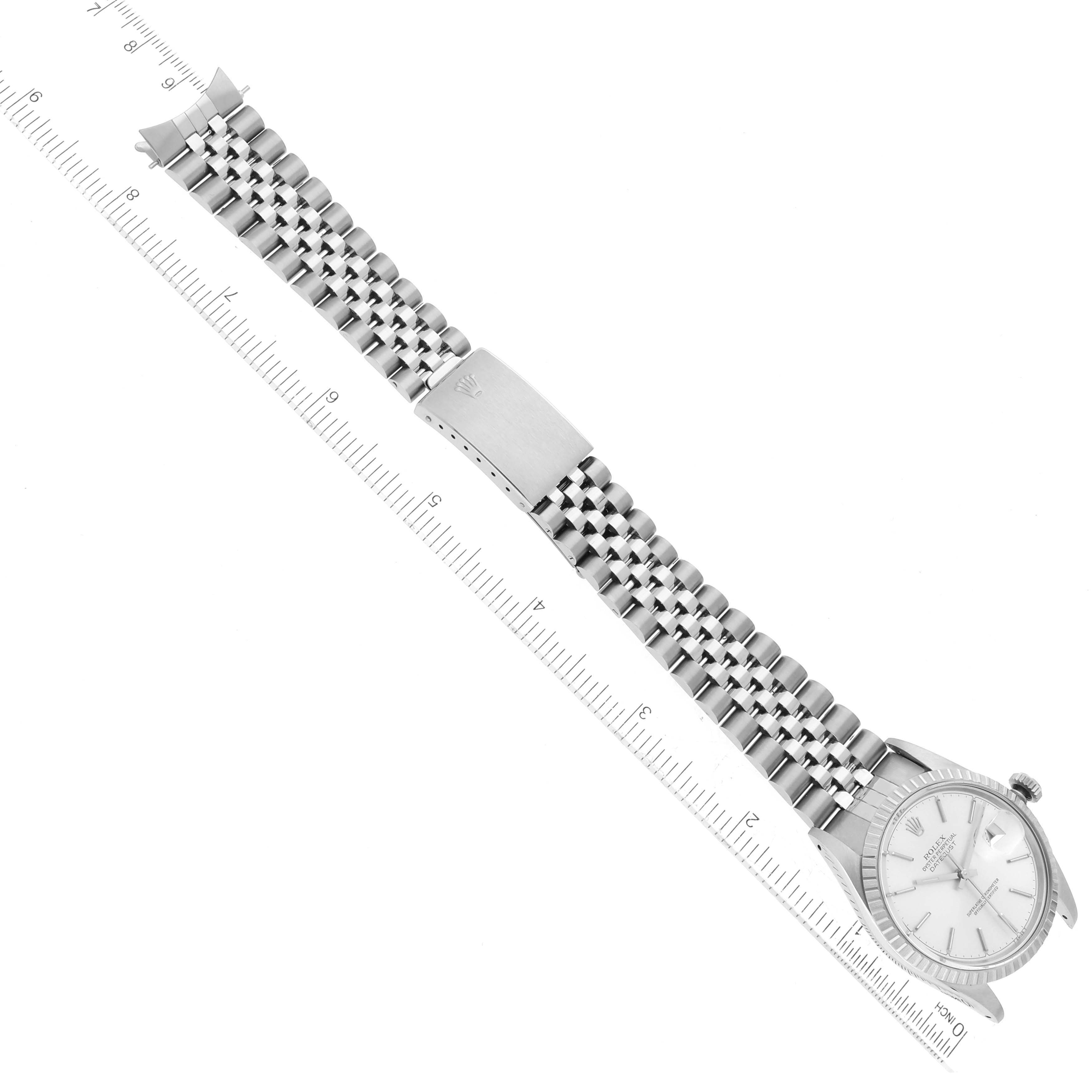 The image shows an aerial view of a Rolex Vintage Collection 16030 Men
s Stainless Steel Silver Dial 16030 Men
s Stainless Steel Silver Dial model watch with its face, bracelet, and clasp visible next to a ruler.