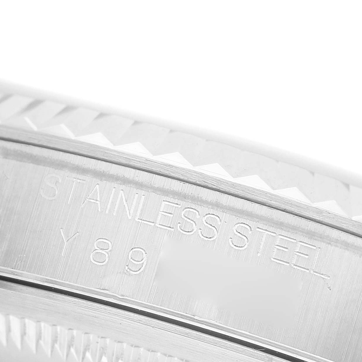 The image shows a close-up of the bezel and engraved side of a stainless steel Rolex Datejust 16234 Men's Stainless Steel Silver Dial watch.