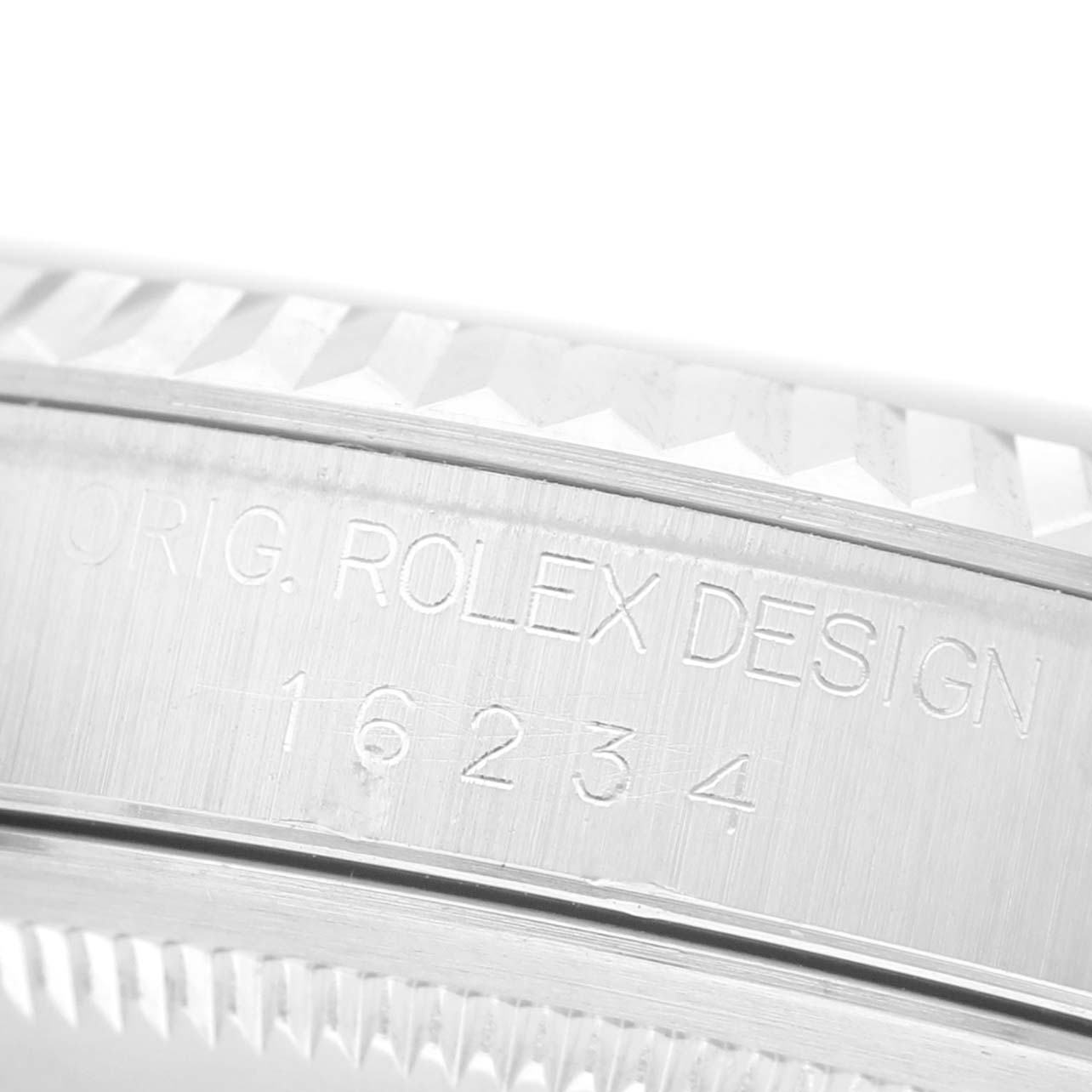 The image shows a close-up of the side bezel and engraved details of the Rolex Datejust 16234 Men's Stainless Steel Silver Dial model.