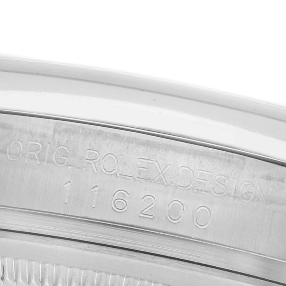 The image shows a close-up of the case engraving for the Rolex Datejust 116200 Men
s Stainless Steel Silver Dial 116200 Men
s Stainless Steel Silver Dial model, displaying its design and model number.
