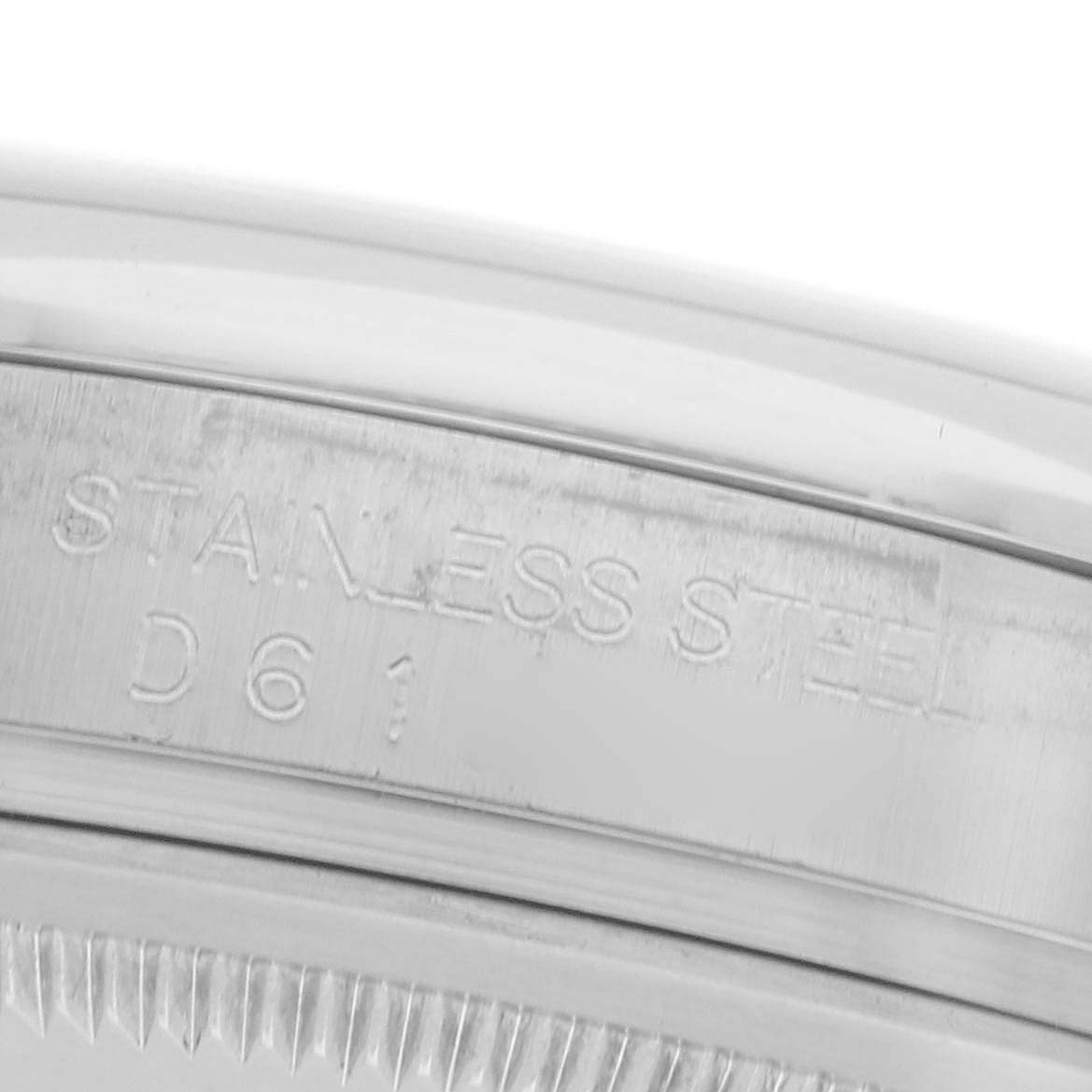 The image shows an angled close-up of the stainless steel bezel edge and engraving on the Rolex Datejust 116200 Men
s Stainless Steel Silver Dial 116200 Men
s Stainless Steel Silver Dial.