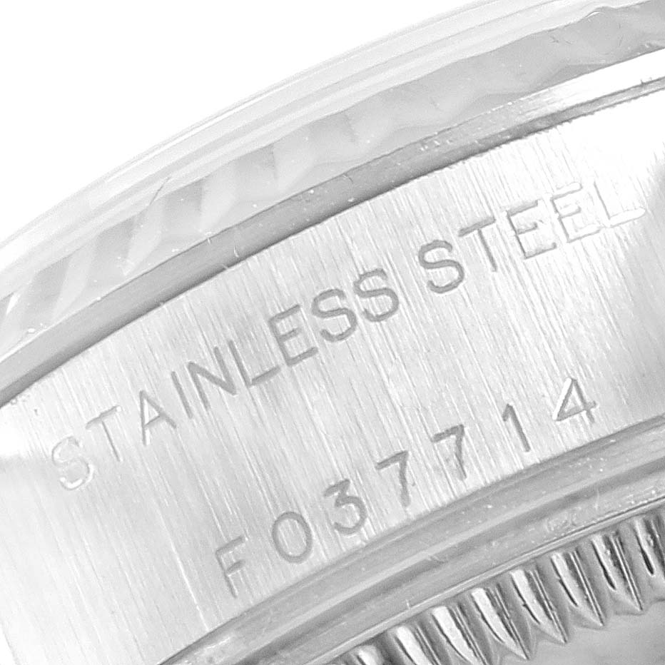 This close-up image of the Rolex Datejust 79174 Women
s Stainless Steel Pink Dial 79174 Women
s Stainless Steel Pink Dial shows part of the case with the "STAINLESS STEEL" engraving and serial number.