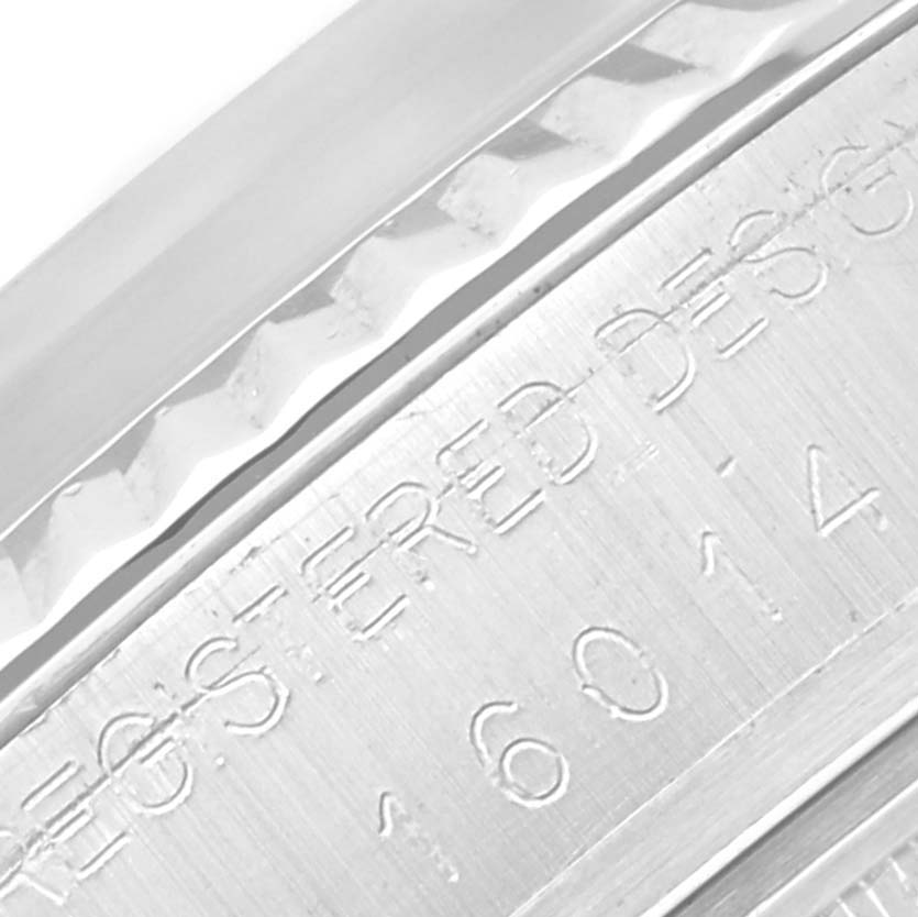 The image shows a close-up of the engraved side of the bezel of a Vintage Collection Rolex watch.